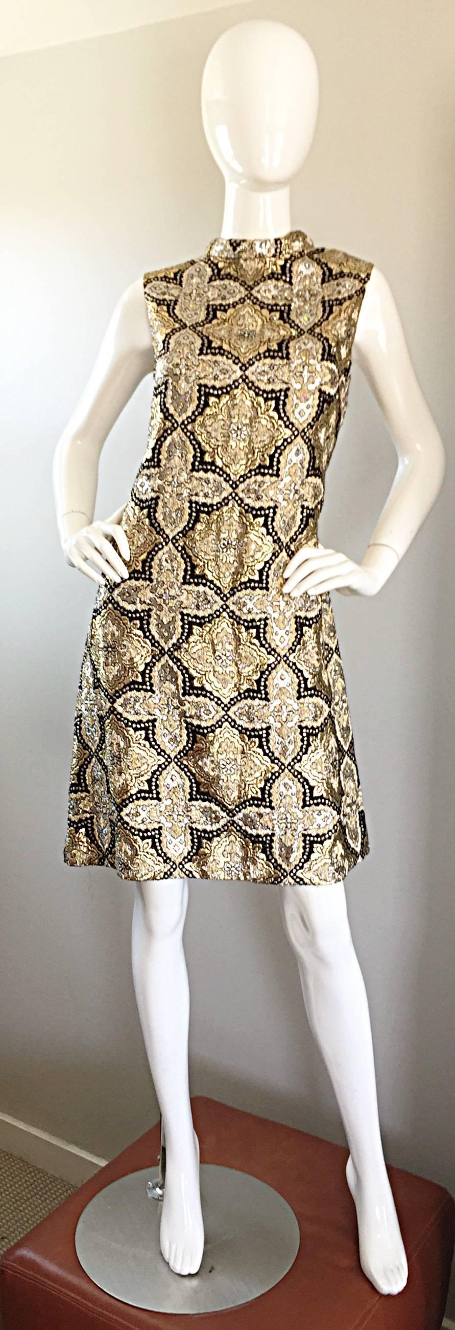 Stunning 60s vintage PAT SANDLER gold, silver and black silk brocade A-Line dress, encrusted with hundreds of hand-sewn rhinestones throughout! Super flattering A-Line fit, with a chic fitted bodice. Beautiful metallic symmetrical crests printed