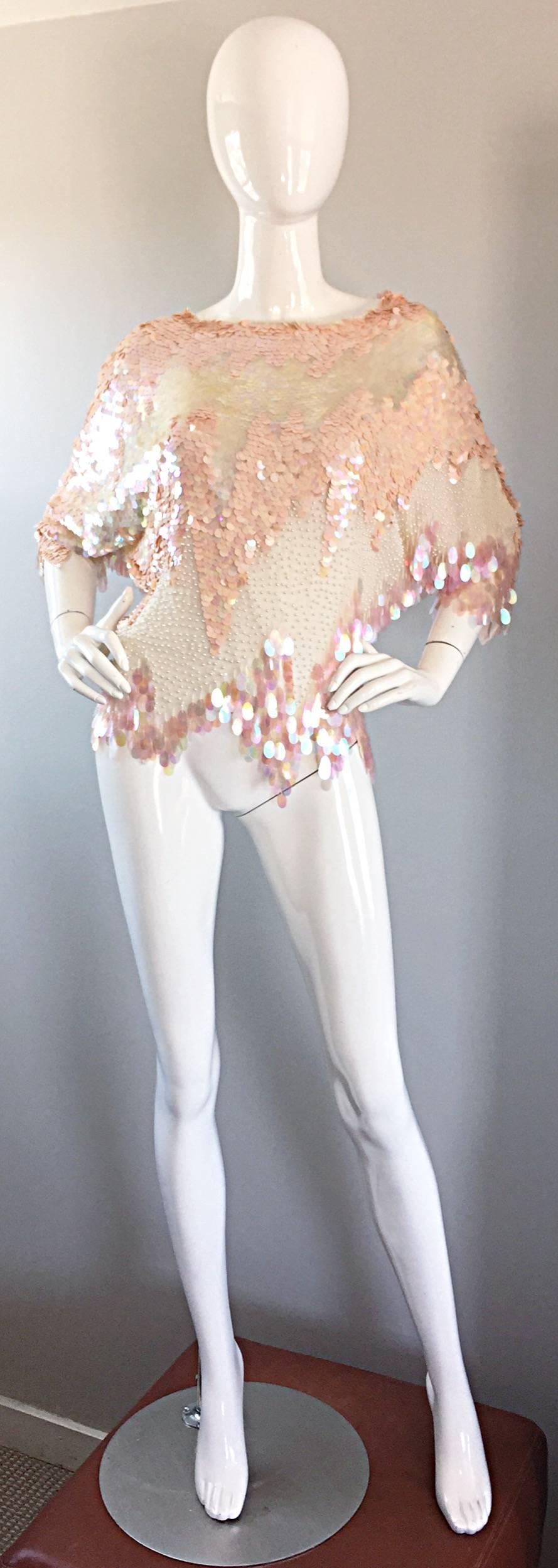 Simply amazing vintage OLEG CASSINI ivory and pink silk blouse! Chic asymmetrical shape, encrusted with thousands of hand-sewn pink and ivory iridescent paillettes throughout, amongst hand-sewn Ivory miniature pearls. Such a smashing vintage top