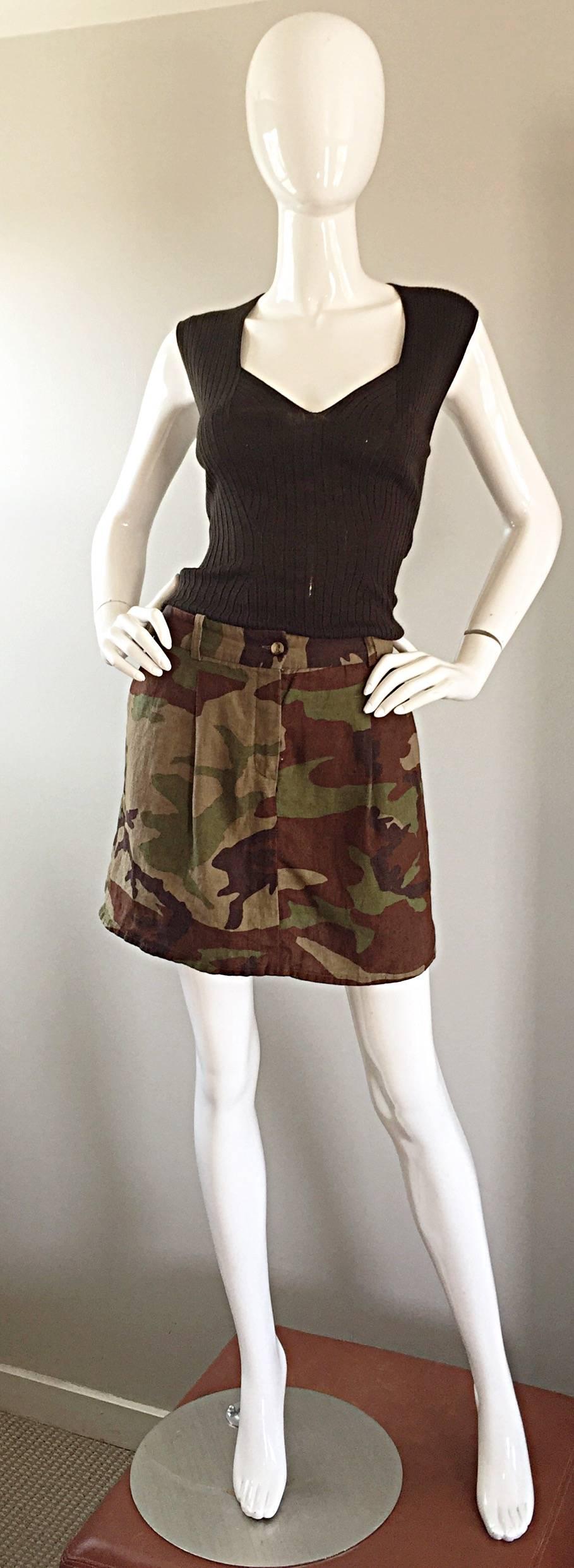 Awesome MICHAEL KORS COLLECTION (Made in Italy) Spring/Summer 2013 sold out camouflage linen skirt! Features all-over signature camo print in greens and browns. Pockets at both sides of waist, and two pockets on rear. Button closure at waistband