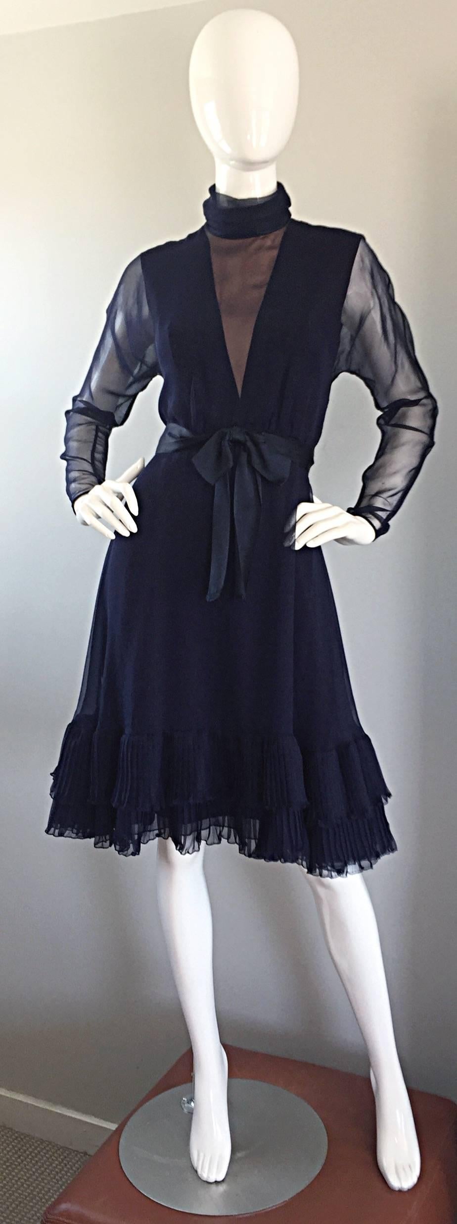 Chic vintage 60s dress from hard to find designer KIKI HART! Beautiful navy blue silk chiffon, with impeccable demi-couture construction! High collar with a nude illusion dip front bust. Semi sheer long dolman chiffon sleeves. Super flattering