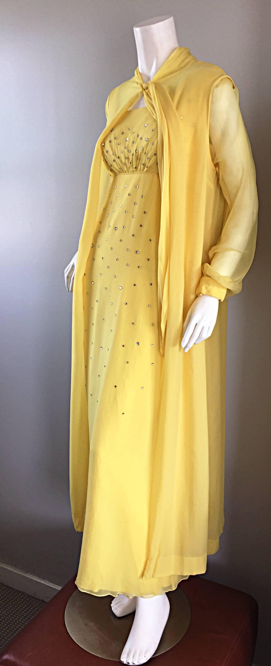 Absolutely fabulous vintage 1970s LORIS AZZARO Couture yellow silk chiffon long sleeve gown and sleeveless cape! Encrusted with hand-sewn rhinestones on the front empire bodice of the gown. This dress screams AMAZING! Chic billow semi sheer bishop