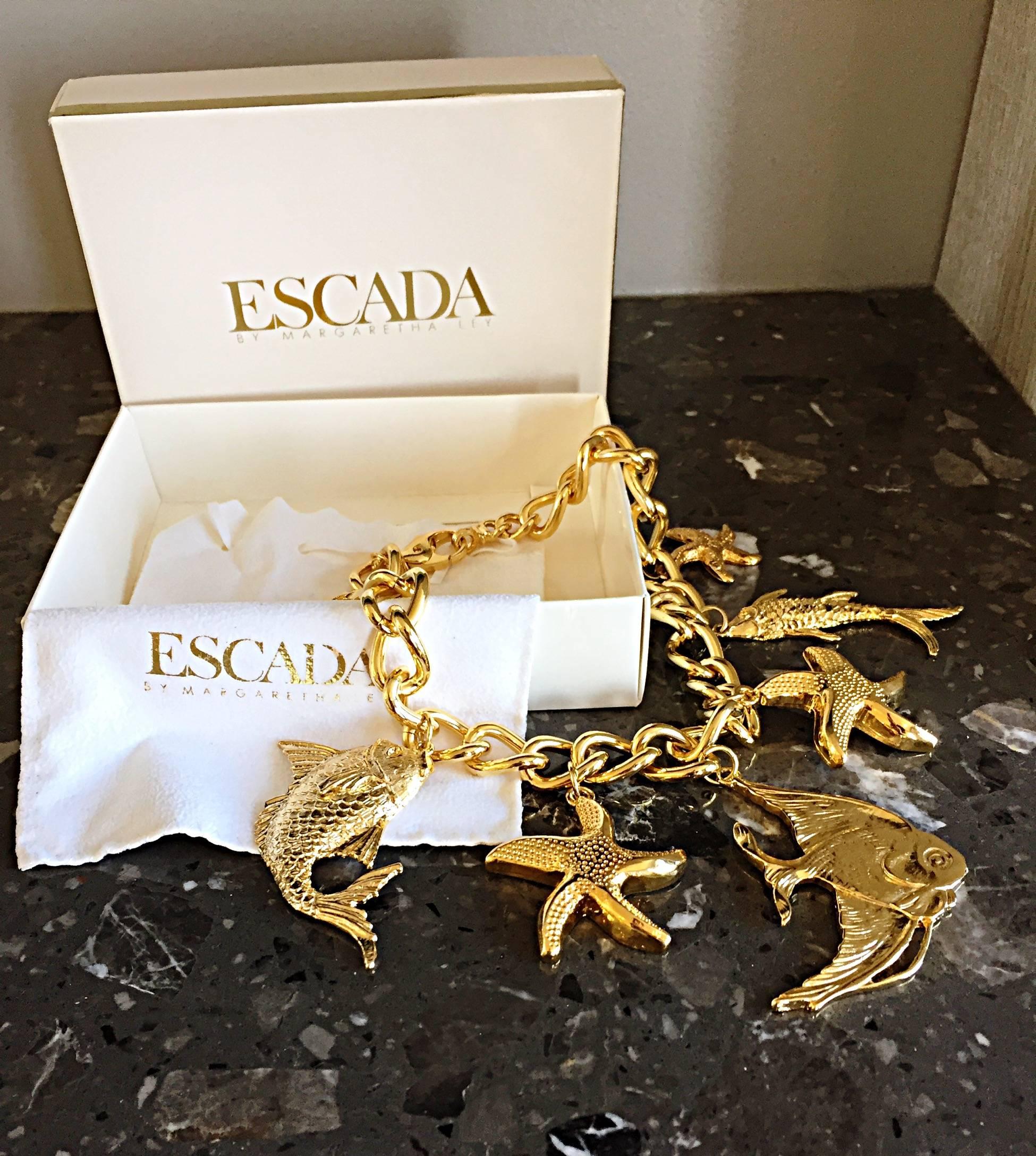 Gorgeous rare vintage ESCADA by MARGARETHA LEY gold oversized charm nautical necklace! Features giant charms of starfish, fish, etc. Comes with the original box and felt protective cover. Looks great with jeans or a dress. Pictured MICHAEL KORS