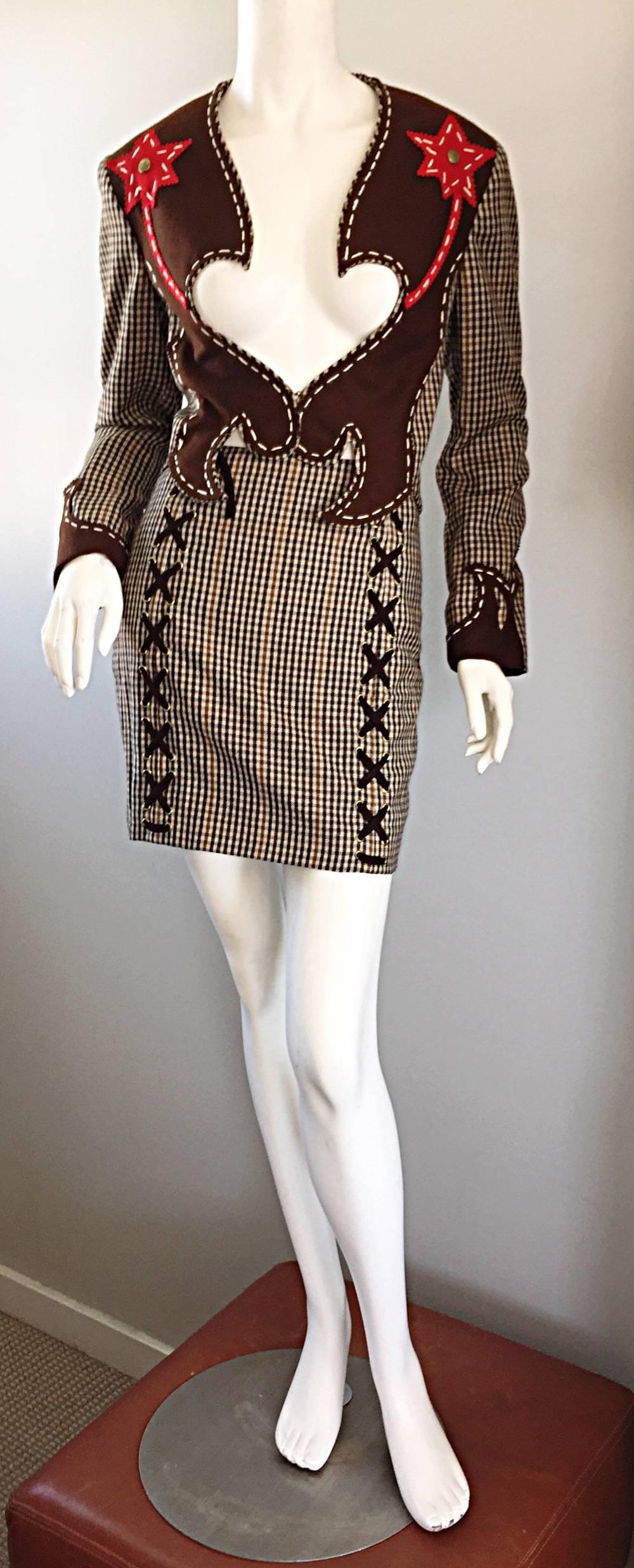 Incredibly rare early 1990s vintage MOSCHINO Cheap and Chic houndstooth plaid 'Sheriff' Collection skirt suit! Features an allover brown and ivory houndstooth gingham print, with thin red lines. Brown suede criss-cross lace-ups at front and back of
