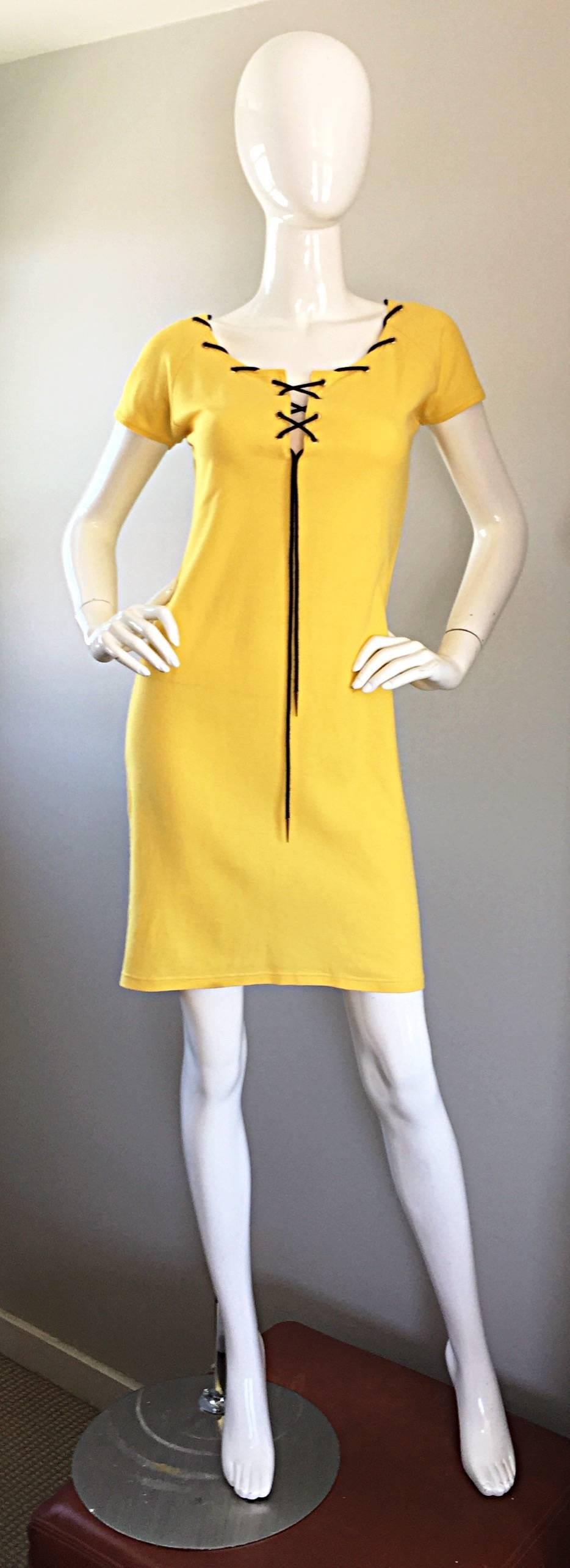 Iconic YVES SAINT LAURENT safari dress, with a twist! Part nautical, part safari chic! Canary yellow knit, with a navy blue cord woven through the collar and bust, with gold spheres at each end of the tassel. Signature YSL logo discreetly woven on