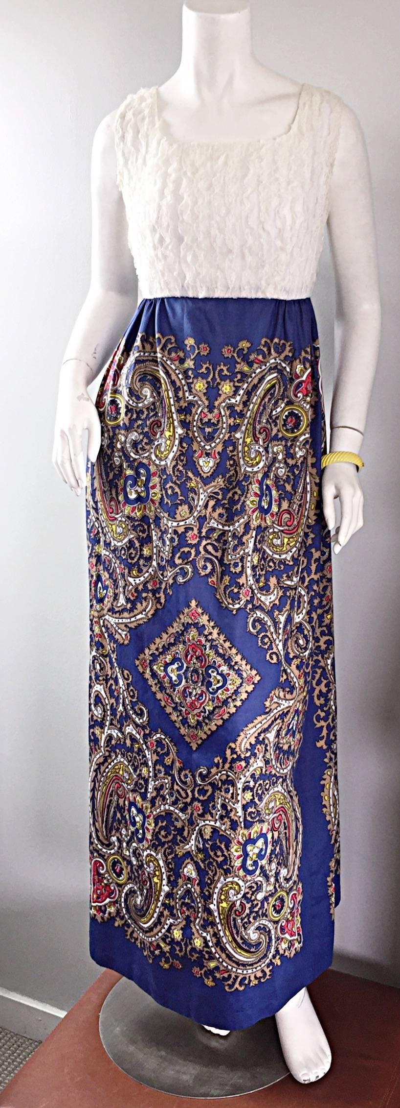 Stunning 1970s bohemian styled dress! Features a white silk French lace vertically tiered bodice, with and amazing paisley screen printed blue cotton skirt. The fabric on this gem is simply divine! Fully lined bodice with a free flowing rich