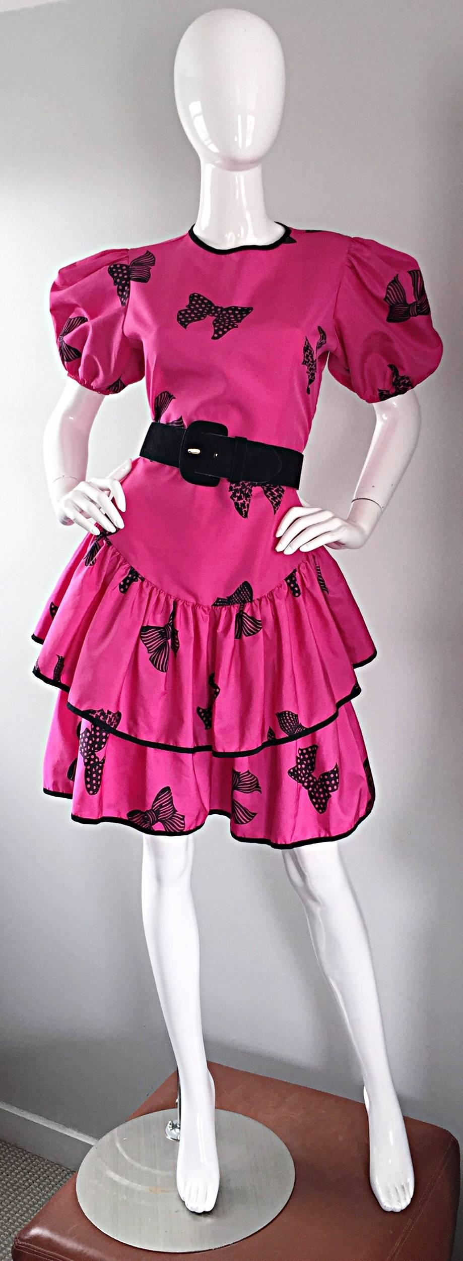 Incredible vintage 1980s BETSEY JOHNSON ' Punk Label ' shocking hot pink and black printed bow dress! There is so much detail to this gem! Tiered cupcake skirt, with a fitted bodice and full pouf sleeves. Black trimmed hems and collar, with elastic