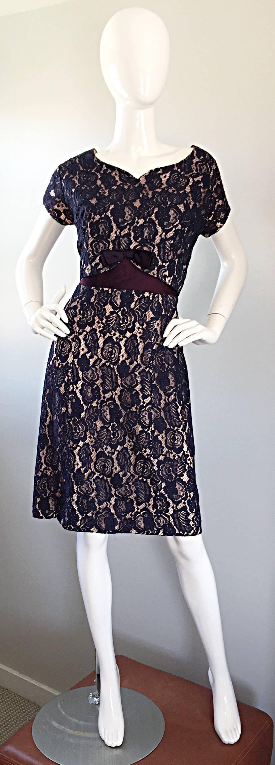 Such a pretty late 1950s 50s navy blue lace A-Line dress! Wonderful fitted bodice, with an attached flare skirt. Attached belt in the back with full metal zipper up the back and hook-and-eye closure. Navy blue lace with silk nude underlay.