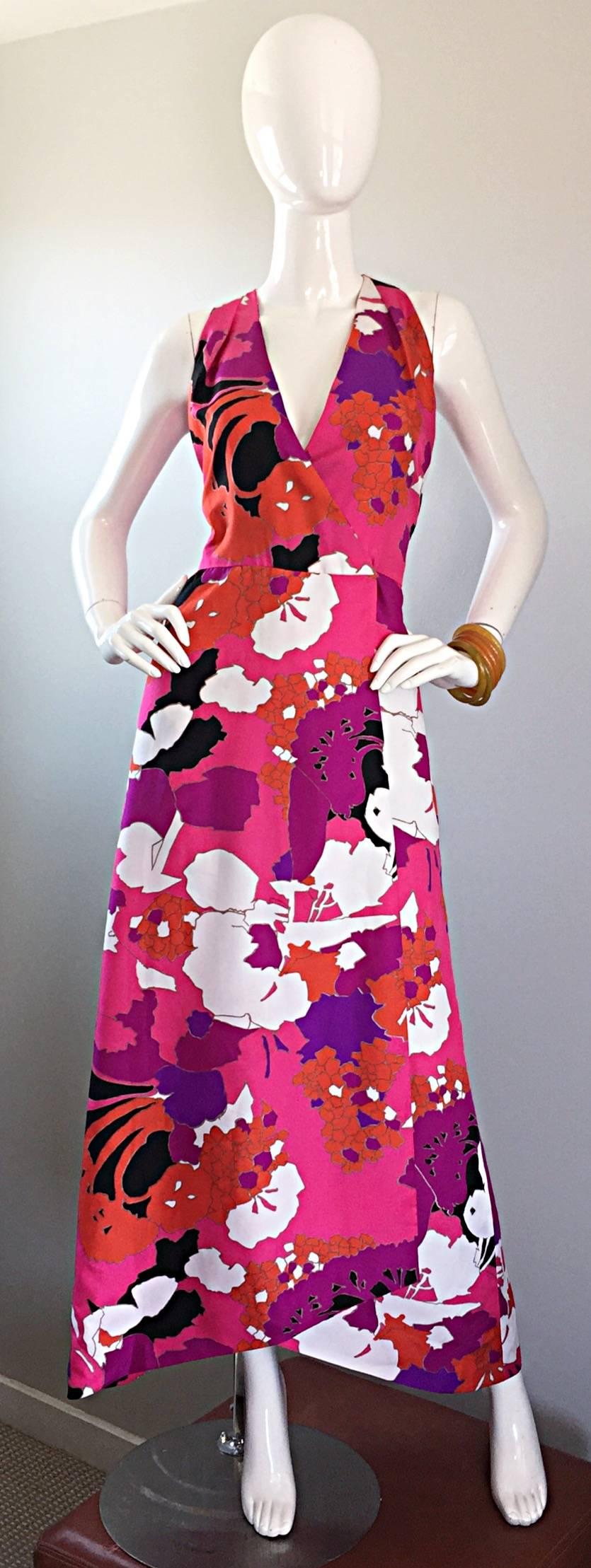 Brilliant 70s ADELE SIMPSON silk halter maxi dress, with a fantastic asymmetrical hem. Vibrant oriental inspired print in vivid hues of neon pinks, purples, oranges, black and white. Flattering wrap style with interior hook-and-eye closures. Looks
