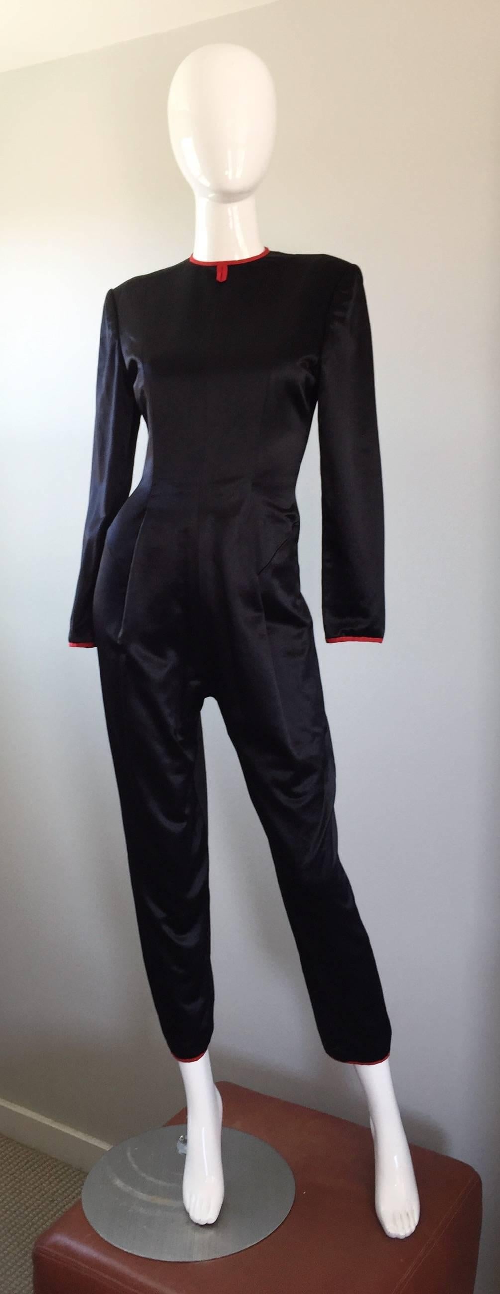 Amazing and rare vintage GEOFFREY BEENE black silk satin jumpsuit / catsuit! Wonderful tailored fit one would expect from the brilliant Beene! Looks great alone or belted. Red satin trim at the collar, sleeve cuffs and hems of the ankles. Hidden