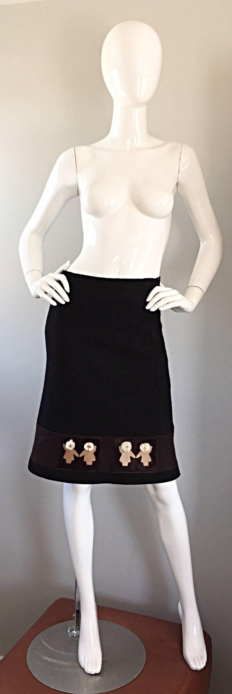 Chic 1990s PRADA black and brown novelty pencil skirt! Black wool, with a horizontal brown stripe at hem, and four adorable ivory and tan Eskimo appliqués. Figure flattering / body huggin fit, with a slight flared hem. Hidden zipper up the side with