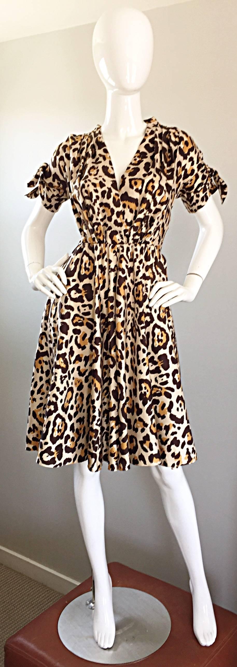 Beautiful JOHN GALLIANO for CHRISTIAN DIOR leopard print 40s style silk dress! Classic animal print on a luxurious silk that flows with the body like fluid!Chic ties at each exterior arm cuff. Flirty skirt with a nipped bodice that flatters the