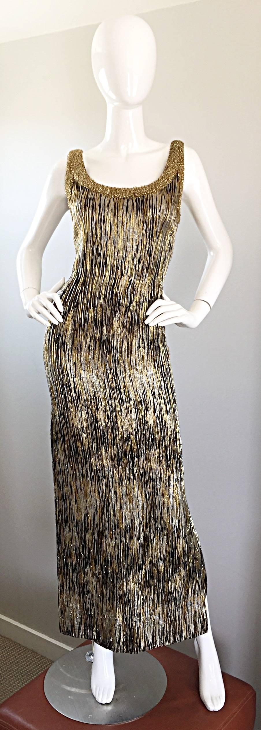 Absolutely extraordinary vintage 60s fully beaded couture silk wiggle gown! Features silk threading and beads throughout the entire dress in gold, silver and black. Extra heavily beaded trim at neck. Slit on the left leg reveals just the right