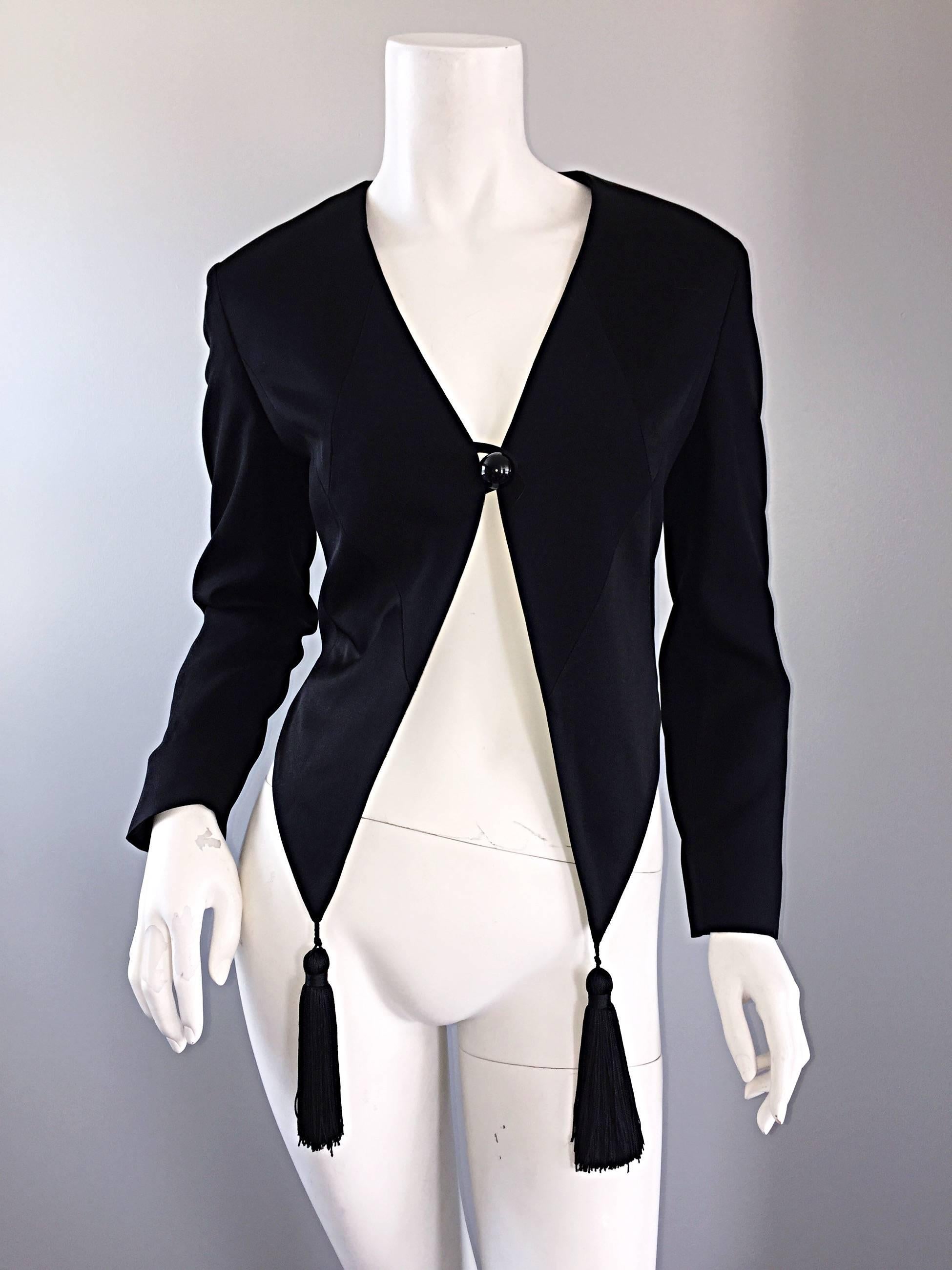 Incredible vintage MOSCHINO "Cheap & Chic" cropped black bolero jacket! Features two tassels at the front hem. Black silk satin triangular patchwork detail on the front. A fabulous fitting classic piece, with the slight quirkiness