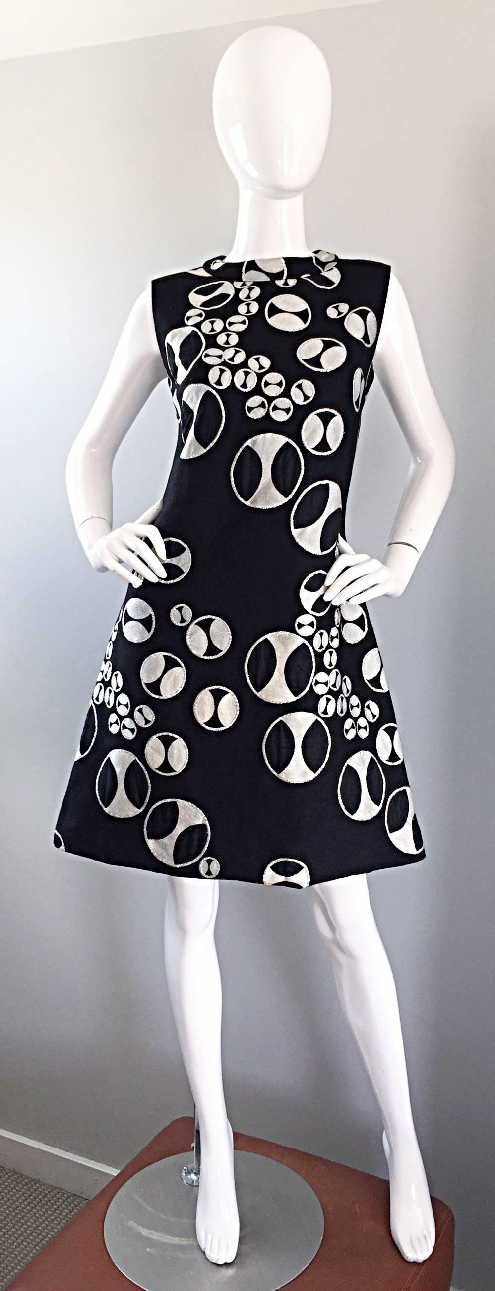 Rare and fabulous 60s vintage HELGA COUTURE black, silver metallic, and white A - Line Space Age sleeveless dress! Features an Op-Art print that looks like buttons printed throughout. Exaggerated A-Line fit is super flattering on! Full metal zipper