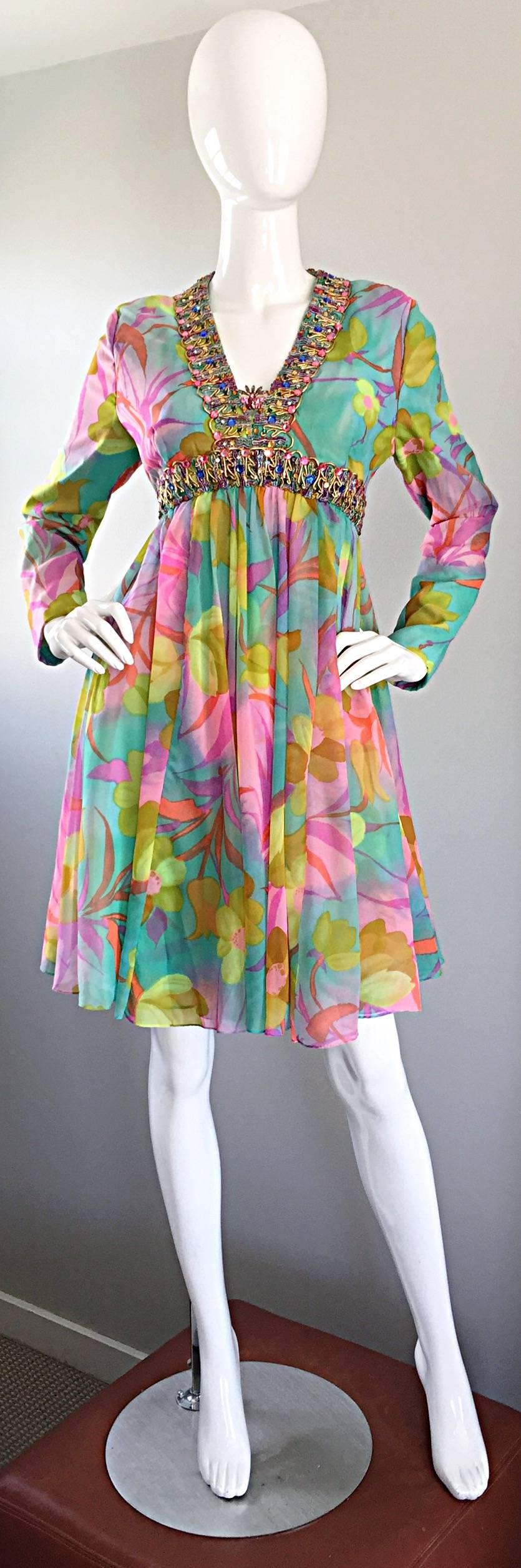 Spectacular vintage 60s I. MAGNIN long sleeve colorful silk chiffon empire waist dress! Features gorgeous flower prints in vibrant hues of pink, purple, blue, and green. Colorful crystal rhinestones encrusted at the bust and waistband. Full metal