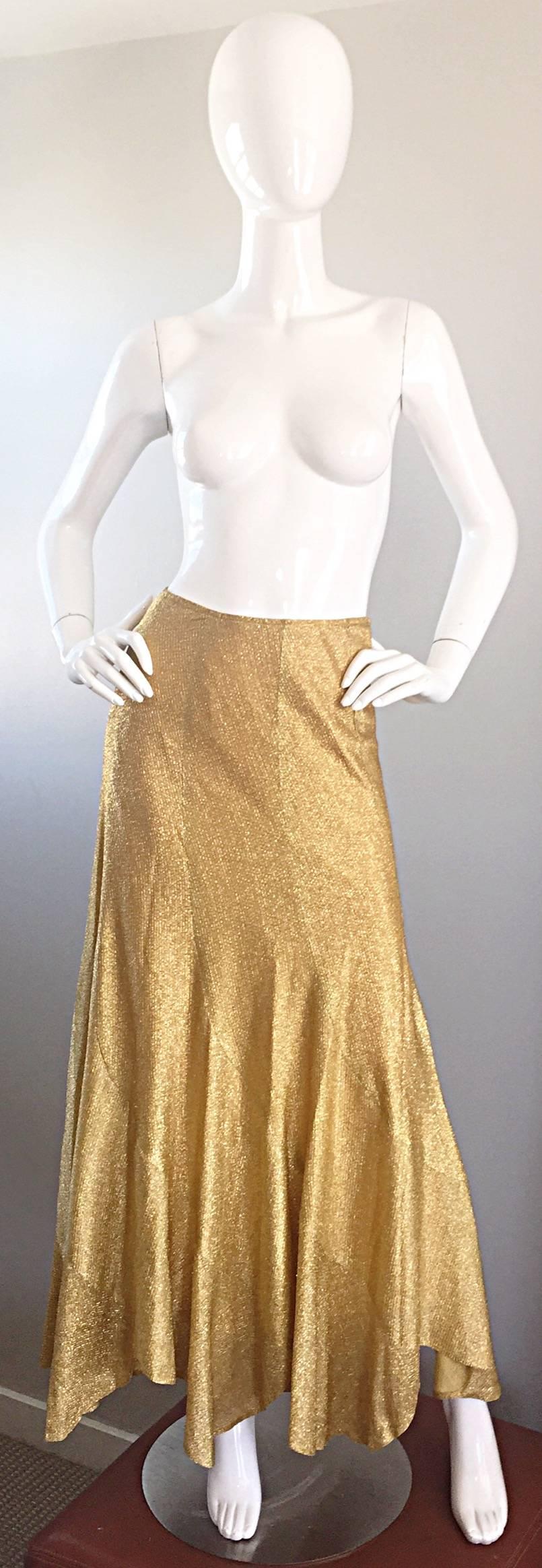 Incredible vintage 70s BEVERLY PAIGE gold metallic handkerchief skirt! Wonderful movement, with a handkerchief hem (asymmetrical lengths). Hidden zipper up the side with hook-and-eye closure. Fully lined. Perfect form day to night. Great with a tee,