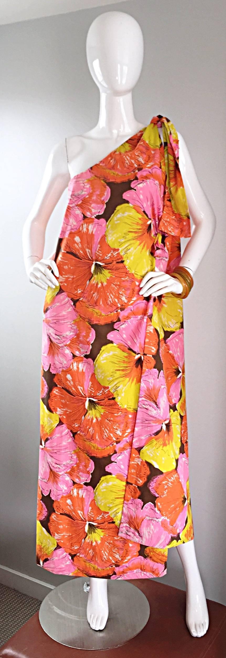 Amazing 1960s one shoulder toga caftan / kaftan maxi dress! Vibrant colorful hibiscus print in pink, yellow, orange, brown and white. Elastic at bust with a tie at one shoulder. Can also be worn as a halter dress (see photo). Lightweight comfortable