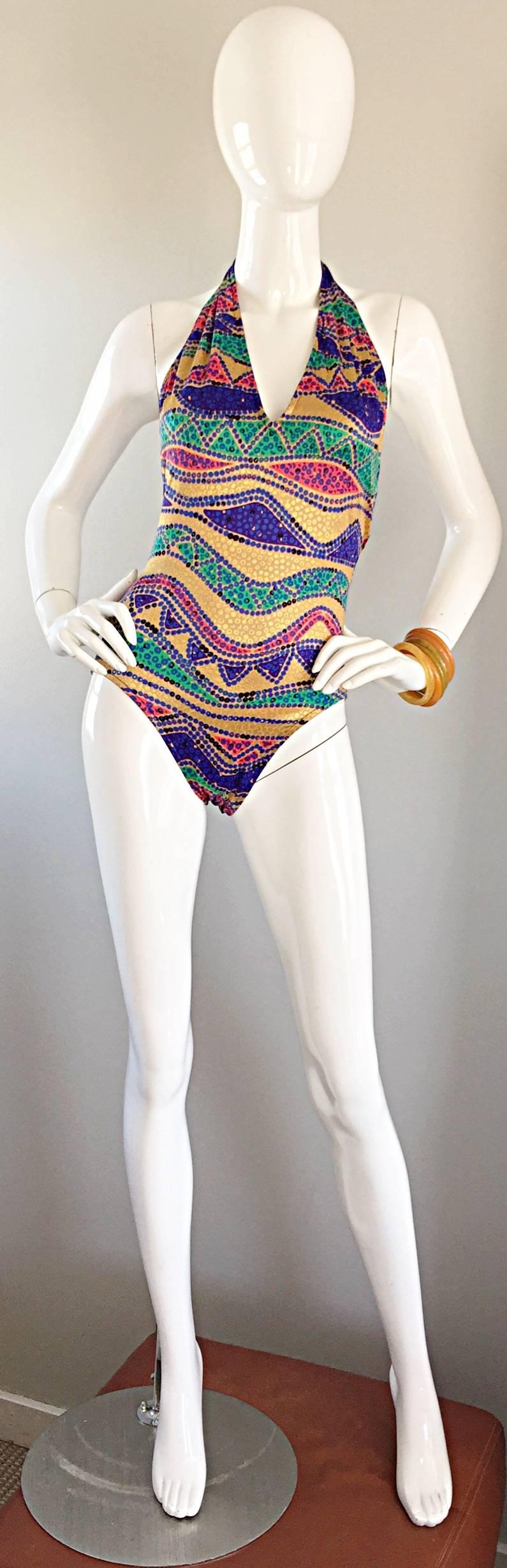 Amazing vintage BILL BLASS 80s one piece swimsuit! Features vibrant colors of blue, red, green and metallic gold in a chic tribal print. Flattering Bodycon fit that is not only great for the pool or beach, but is totally in fashion to wear as a top