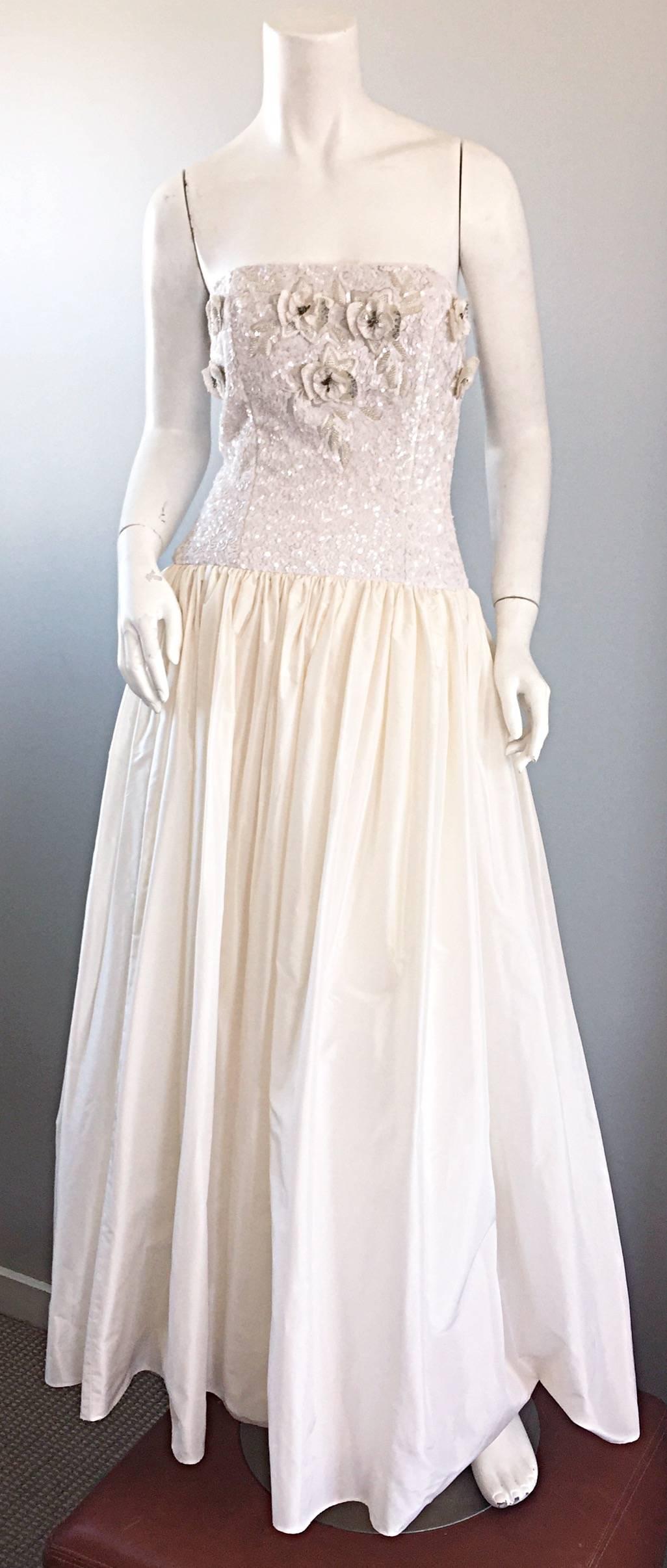 Sensational vintage 1980s RICHILENE Couture white sequined and beaded full length strapless gown! Features thousands of hand sewn sequins and beads on the bodice, along with beaded flower appliques throughout. Incredible full taffeta skirt looks