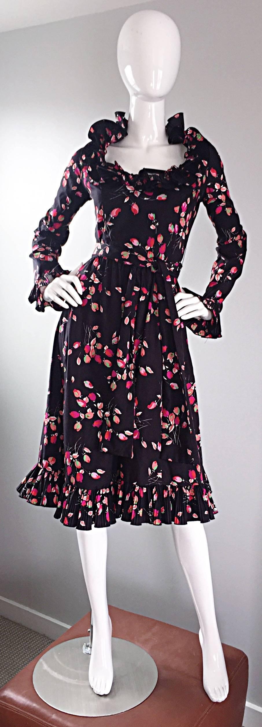 Wonderful 1970s VICTOR COSTA black taffeta ruffle dress with printed tulips throughout. Colorful pink, red, white and green printed tulips. Detachable sash belt. Flattering accordion ruffles around the neck, and at each sleeve cuff. Full metal