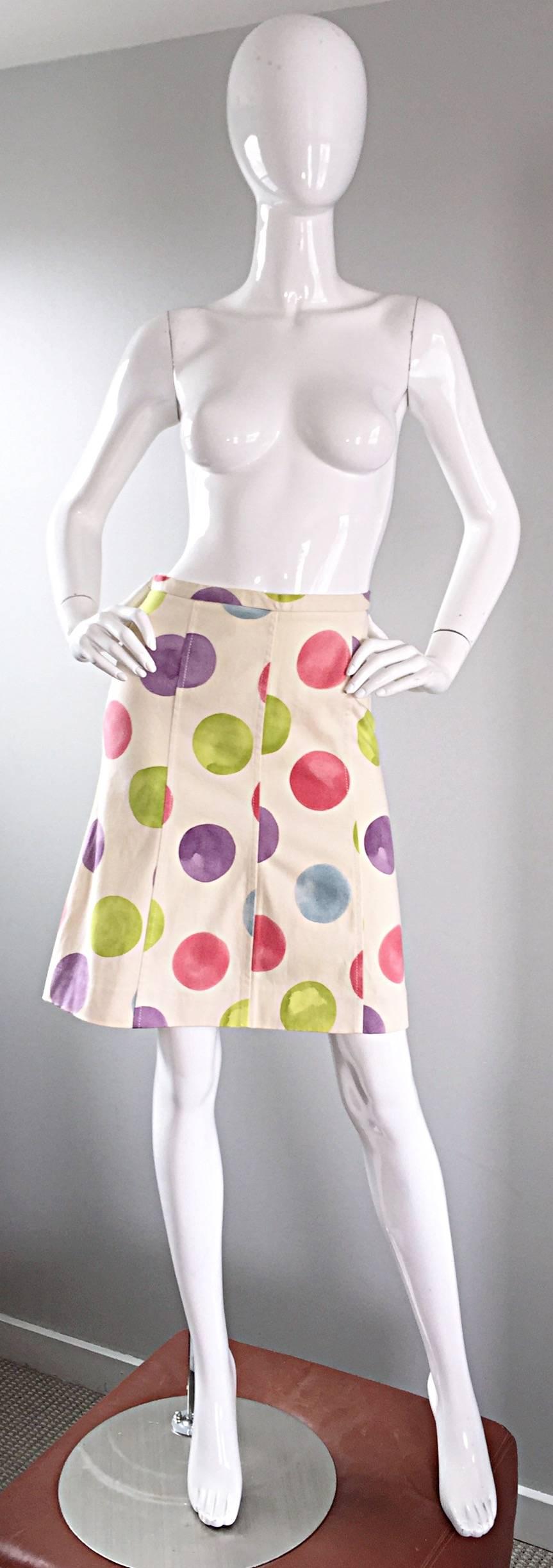 Adorable vintage 1990s MOSCHINO 'CHEAP & CHIC' ivory multi colored A-Line skirt! Soft ivory cotton with stretch. Pastel purple, pink, blue, and green tie dye polka dots throughout. Hidden zipper up the side with hook-and-eye closure. Flattering fit.