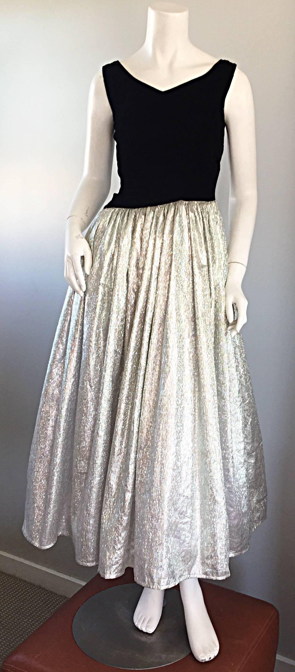 Beautiful 1980s does 1950s black and silver iridescent metallic pouf dress! Features a slight asymmetrical fitted black velvet bodice with a wonderful silver iridescent full skirt, that gives off a 'prism' effect in the light. Hidden zipper up the