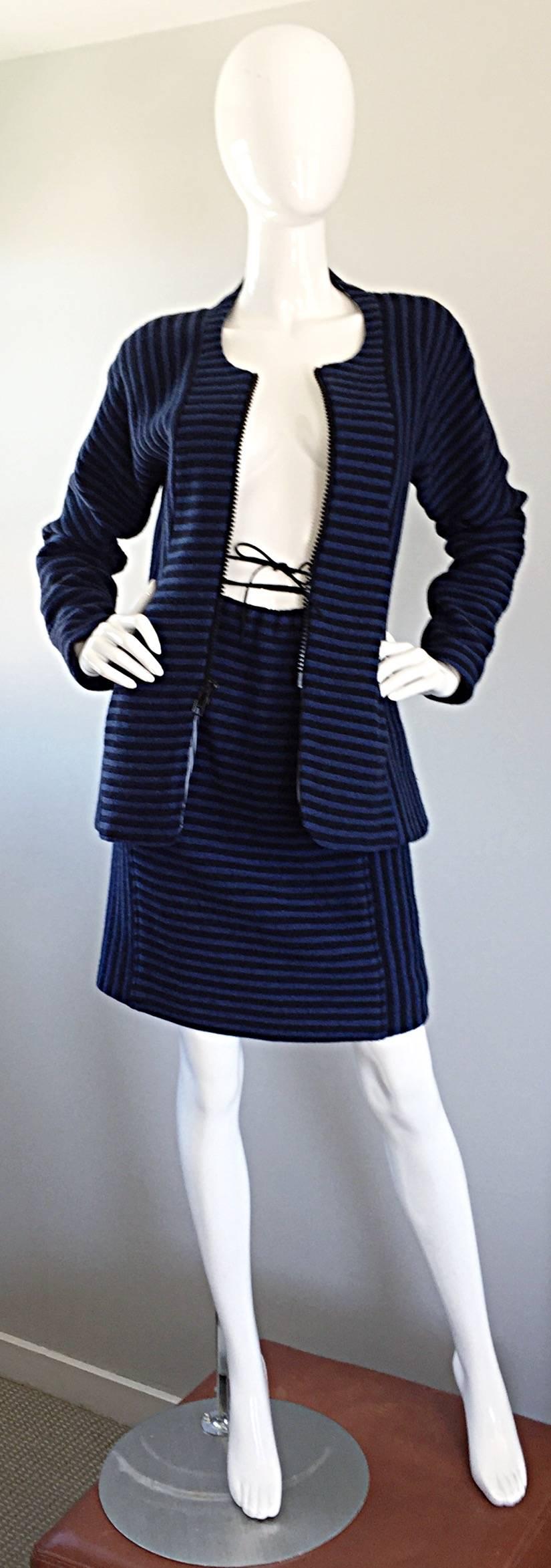 Amazing vintage GEOFFREY BEENE royal blue and black striped wool skirt suit! Features an amazing fitted jacket, with an oversized black zipper up the bodice. Mini skirt features a suede tie that can be wrapped around the waist, or ties above the