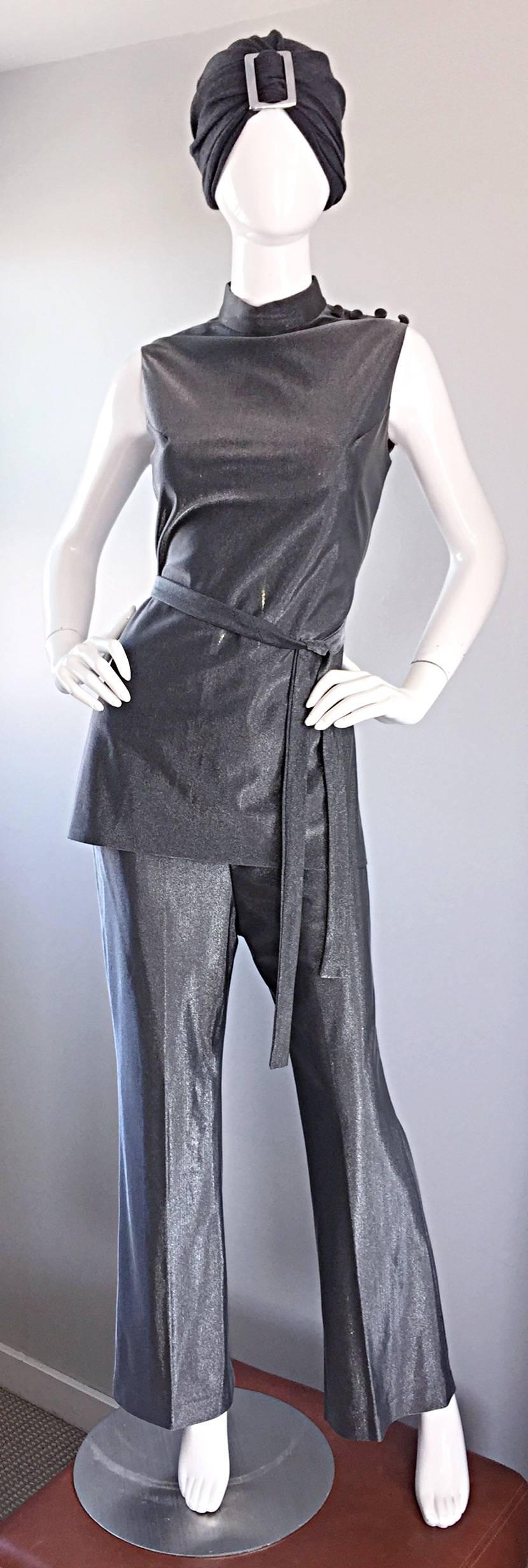Exceptional vintage 1970s three piece metallic gunmetal / grey ensemble! Features a fitted tunic top with mock fabric covered buttons at top left shoulder. Metal zipper up the back with hook-and-eye closure. Matching detachable belt (also works as a