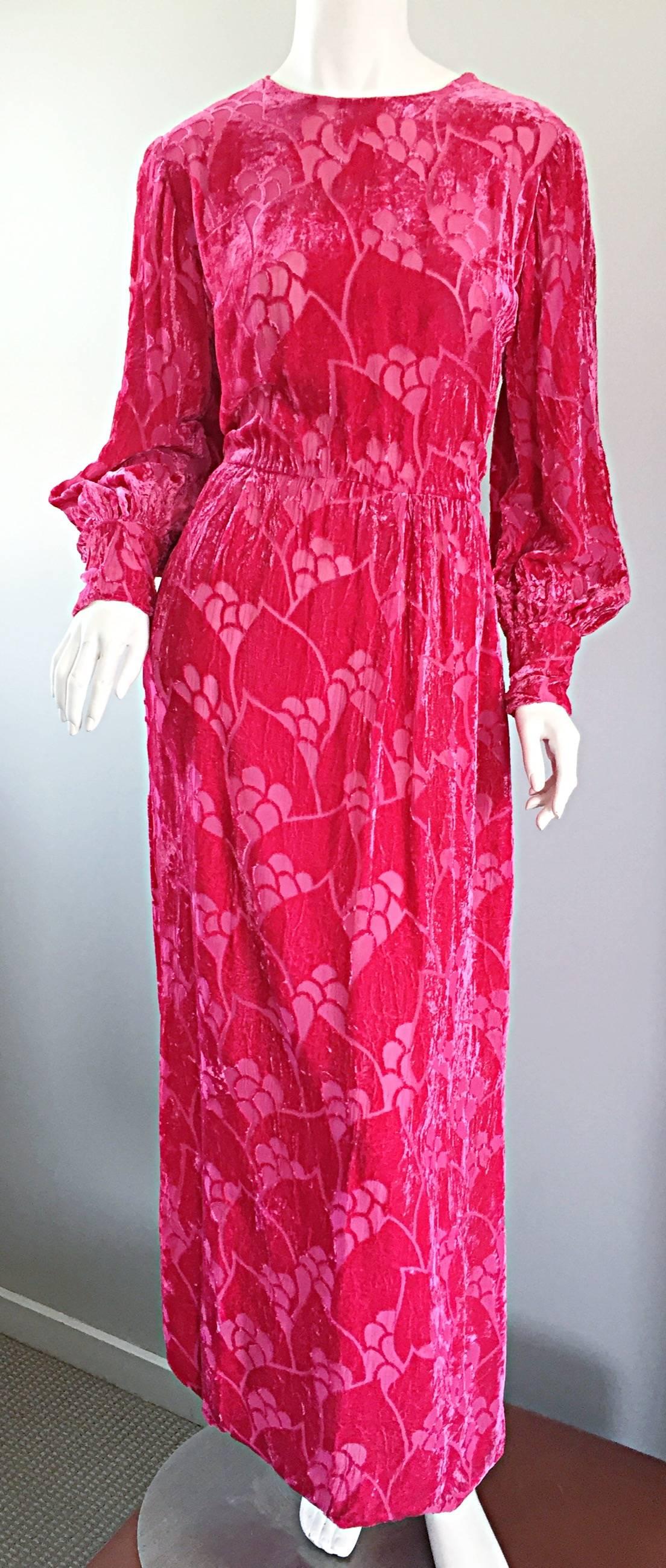 Beautiful vintage early 70s hot pink / fuchsia silk crushed velvet long sleeve gown! Features full bishop sleeves, a fitted bodice, and a breathtaking dramatic skirt that looks incredible with movement! Chic cut-out designs, with chiffon backing.