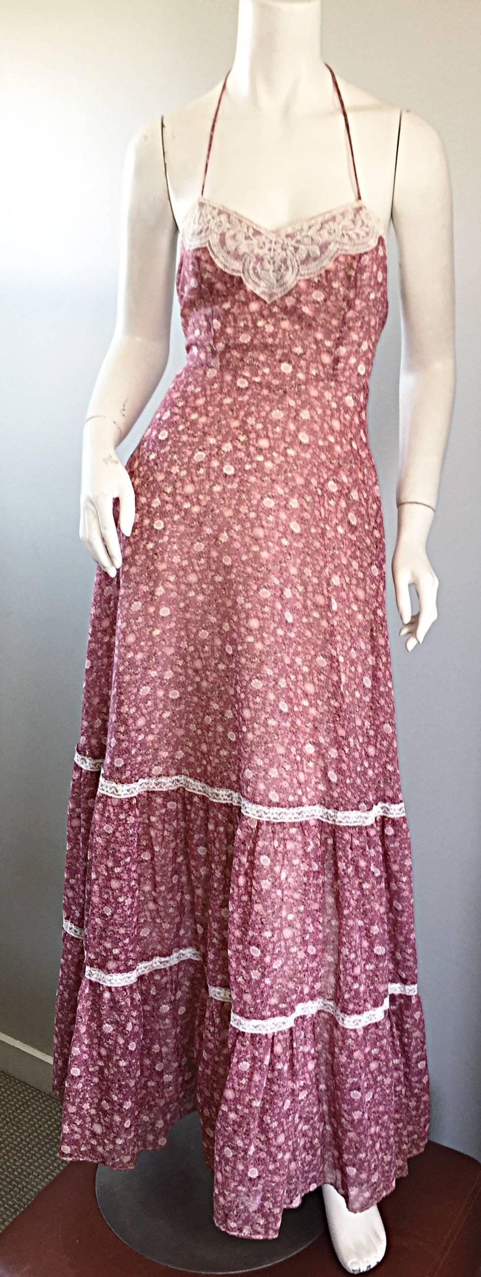 Amazing vintage 70s boho prairie maxi dress! Raspberry pink mini flowers printed throughout, with ivory lace accents at the bust, and at the tiers on the skirt. Sexy open back with ties at both the waist and back neck. Full metal zipper up the back.