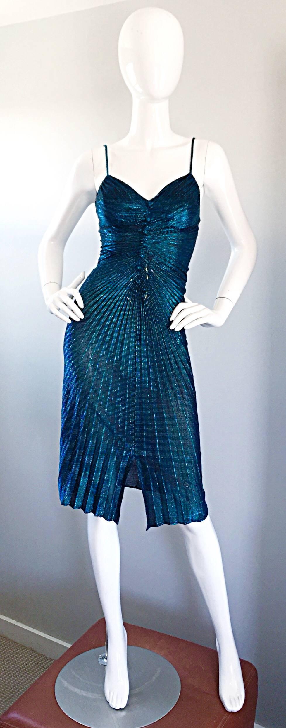 Sexy vintage 1970s SAMIR electric blue metallic pleated disco dress! Features a wonderful fitted pleated bodice, with mock fabric covered buttons up the front. Thin spaghetti straps at each shoulder. Flirty diagonal pleated skirt. Hidden metal