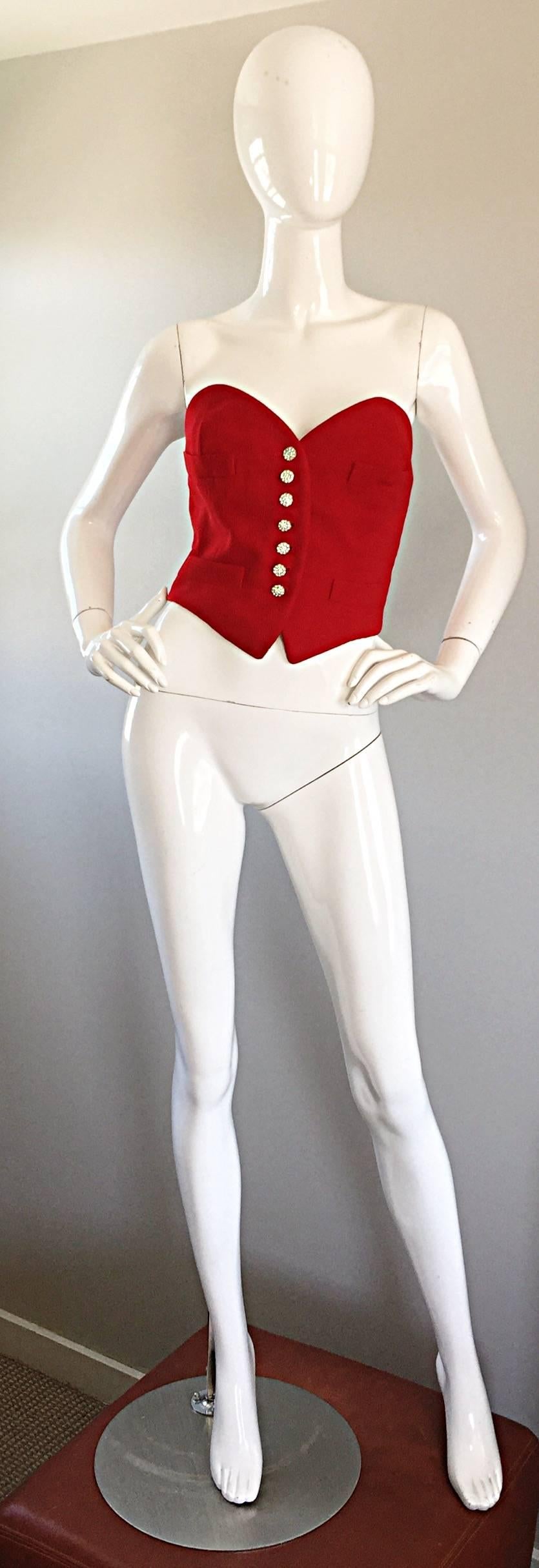 Rare and exceptional vintage MOSCHINO COUTURE red 'heart' shaped silk strapless corset bustier blouse! Per Moschino's typical with and high sense of fashion, this beauty proves to be both flattering and stylish! Features seven rhinestone encrusted