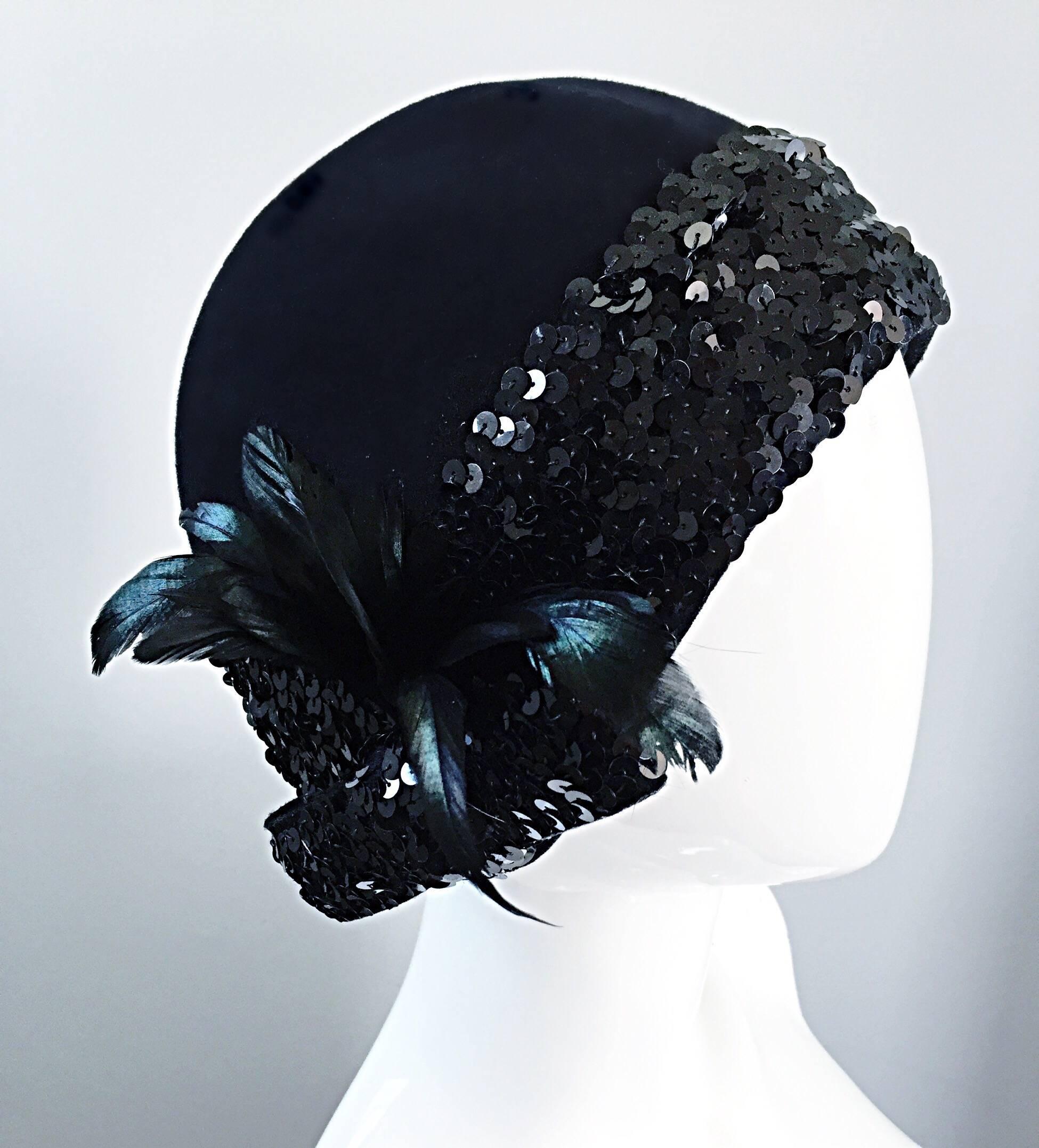 Wonderful vintage 1960s does 1920s ADOLFO black virgin wool cloche hat! So much detail on this rare gem. Features rows of black sequins around the entire trim. Iridescent feathers one one side, with a chic sequin bow under. Great with jeans, yet