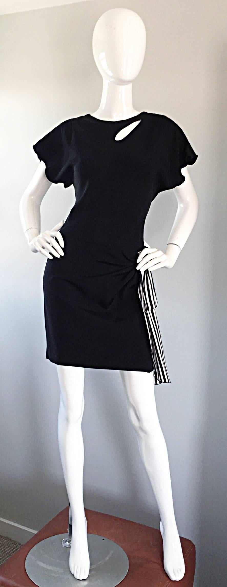 Avant Garde vintage HOLLY'S HARP black silk jersey dress! Features cut-out detail at top left bodice. Flattering gathers at waist, with a black and white silk strip, adorned with a beaded flower applique. Chic dolman sleeves make this beauty easy to