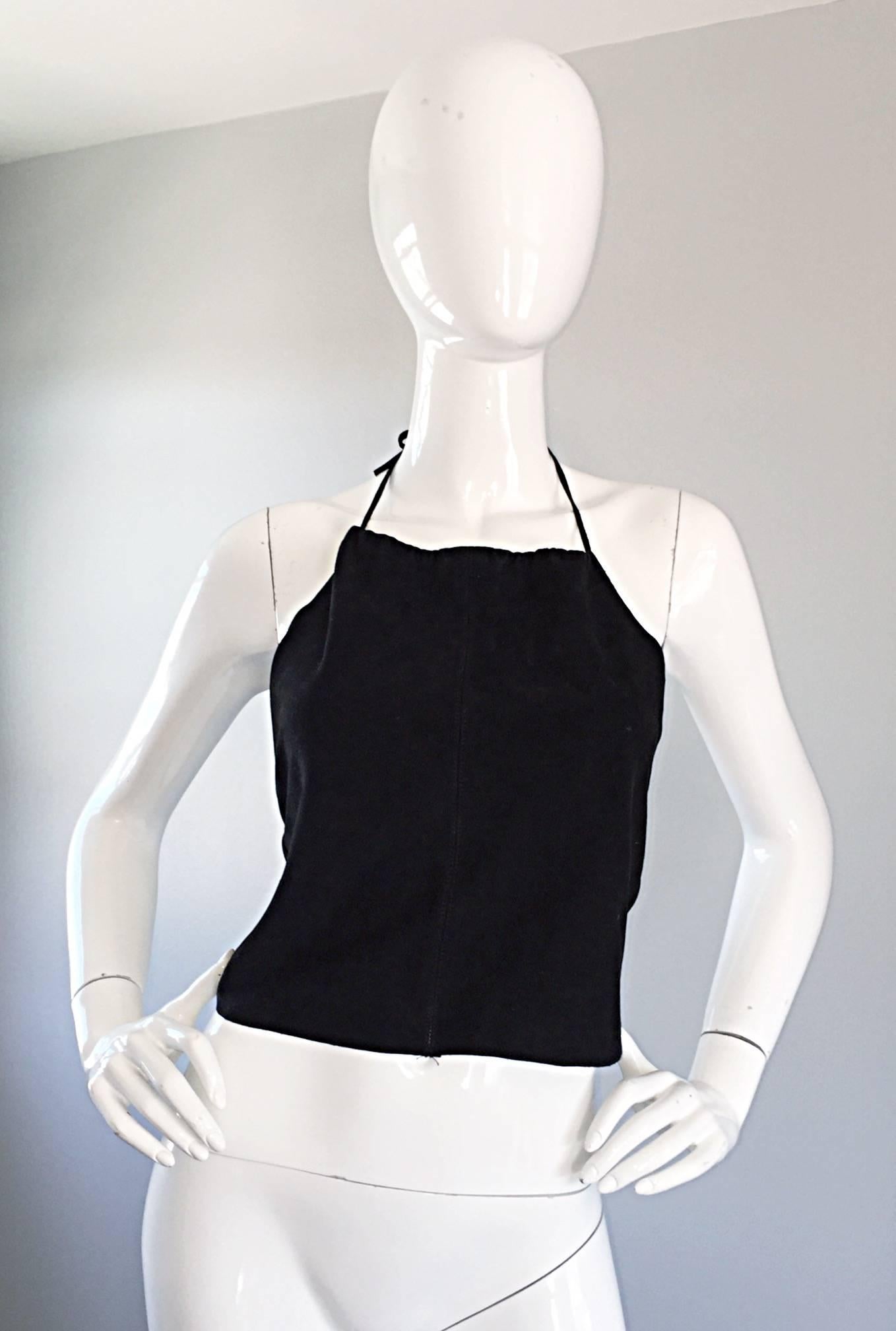 Sexy vintage GEMMA KAHNG black suede halter crop top! Features a tie at the neck and hook-and-eye closures up the back. Looks great on the body, and can easily be dressed up or down. Great with shorts, jeans, trousers or a skirt. In great condition.