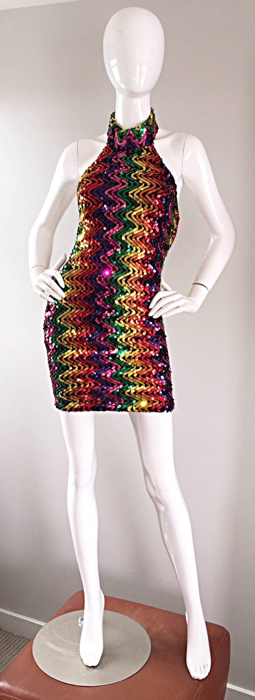 Simply amazing 1990s vintage fully sequined RAINBOW mini halter dress! A definite statement worthy dress that looks amazing on! Comfortable black stretch knit hugs the body in all the right place and stretches to fit. Two buttons closures at the top