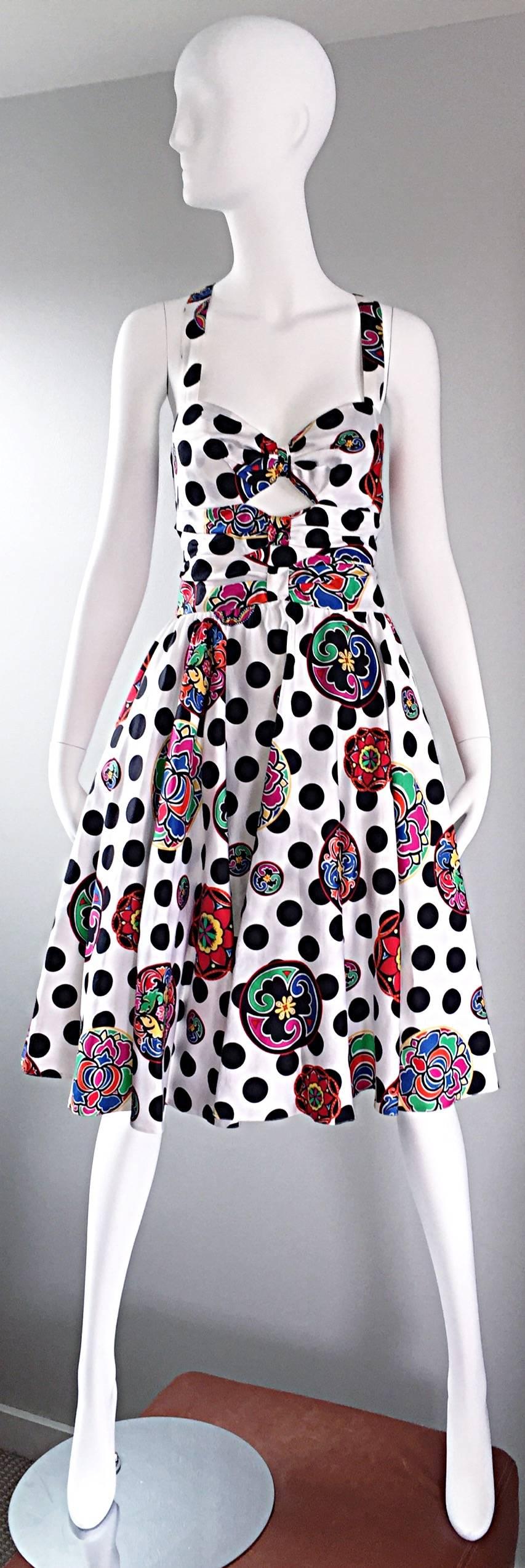 Incredible vintage LOUIS FERAUD black and white polka dot dress, mixed with a tiki themed colorful print throughout! Chic cut-out at the center bust reveals just the right amount of skin. Boned bodice keeps everything in place. Halter style neck