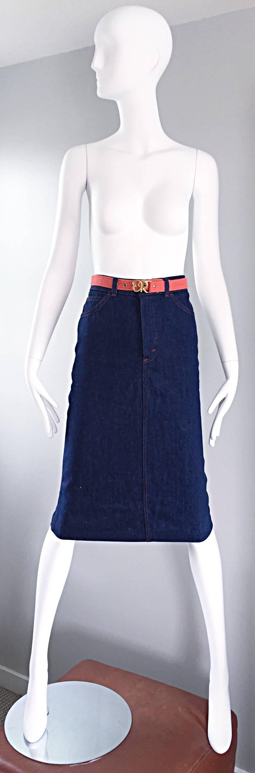 Chic vintage OSCAR DE LA RENTA high waisted indigo denim belted deadstock (still has tags attached) pencil skirt! Wonderful flattering fit, with a removable coral belt with gold logo buckle. Zipper fly with button closure. Two pockets at each side