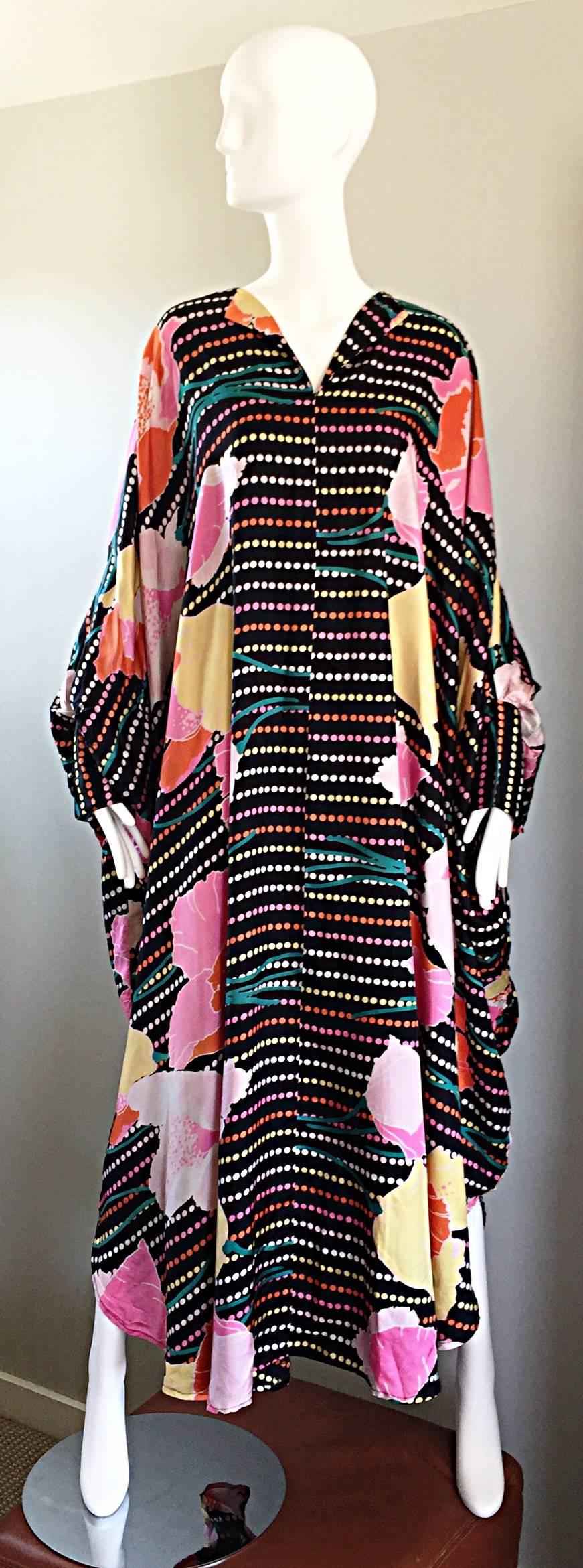 Incredible vintage 1970s LOIS MYERS polka dot and floral colorful kaftan maxi dress! Black backdrop with neon polka dots and abstract flowers throughout. Cuff at each sleeve hem. The perfect statement piece! Great for beachwear, the pool, running