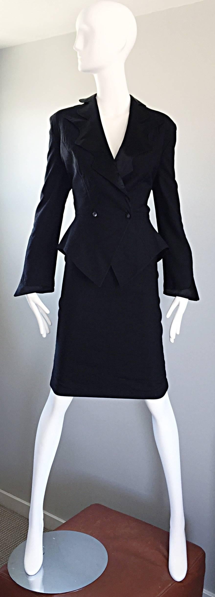 Iconic and rare vintage 90s THIERRY MUGLER black open-back fitted skirt and jacket suit! There is so much detail to this little gem, I do not even know where to start! Snaps shut on the front blazer waist, with signature silk satin asymmetrical