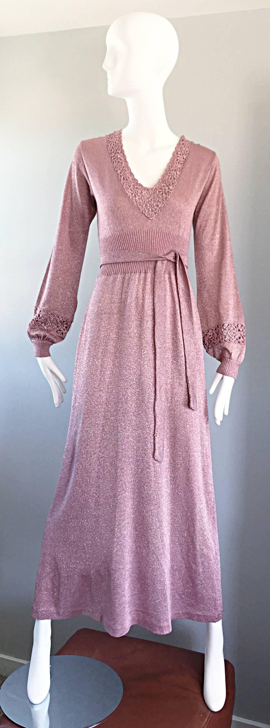 Beautiful vintage 70s pink / dusty rose metallic lurex long sleeve maxi dress! Wonderful fitted bodice, with a v-neck that is hand crocheted around the collar. Sleeves feature a fitted cuff with matching crochet detail. Detachable belt can also be