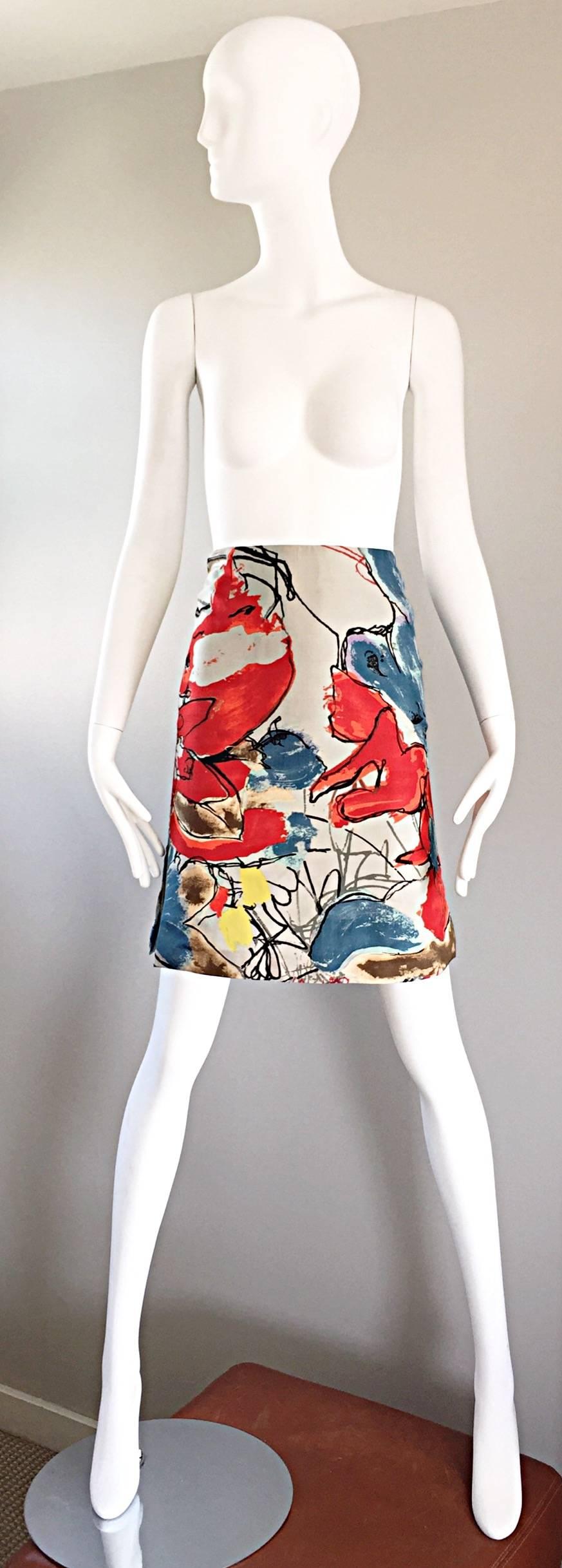 Wonderful vintage 90s CHRISTIAN LACROIX high waisted mini pencil skirt! Pale grey silk with vibrant colors of red, blue, yellow, orange, black and browns throughout. Hidden zipper up the back with hook-and-eye closure. Fully lined. Super flattering