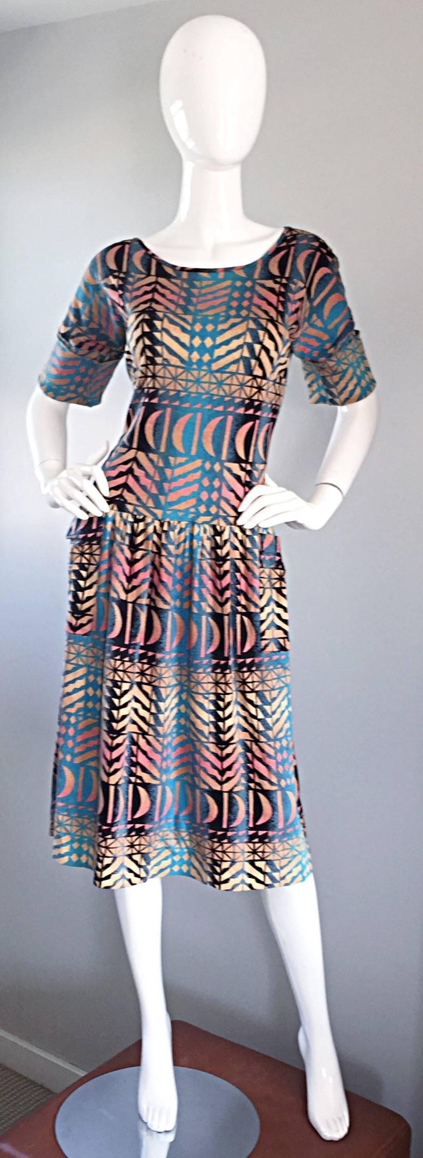 Amazing vintage 90s VESNA BRICELJ Italian artist made short sleeve t-shirt dress! Features wonderful vibrant colors, with geometric 3-D prints throughout. Pockets at each side of the waist, and cuffs at each sleeve. Chic, yet insanely comfortable