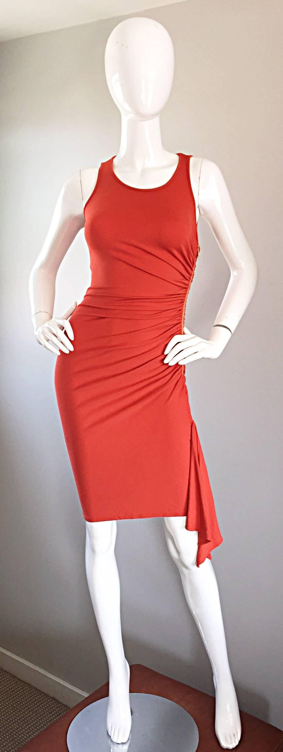 Beautiful MICHAEL KORS Collection signature burnt orange sleeveless jersey dress! Flattering ruching at the side, with an exposed gold zipper and hidden snap to secure the zipper. Asymmetrical hem. Signature double face jersey hugs the body in all