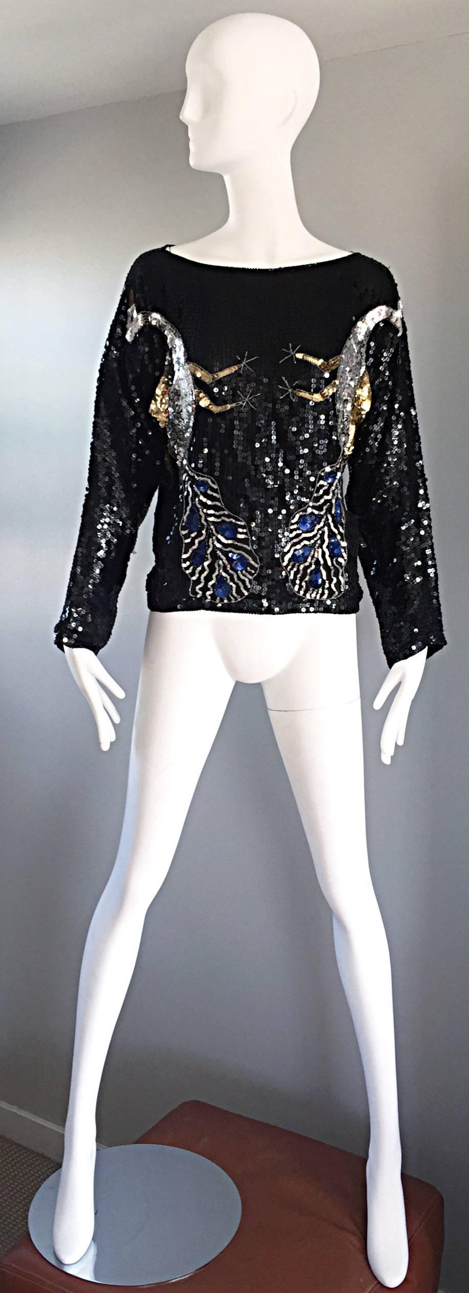 Amazing vintage novelty silk sequined blouse! Features thousands of hand-sewn sequins and beads that form four peacock birds (two on the fron and two on the back). Peacocks are sequined in blue, gold and silver, along with hundreds of hand-sewn seed