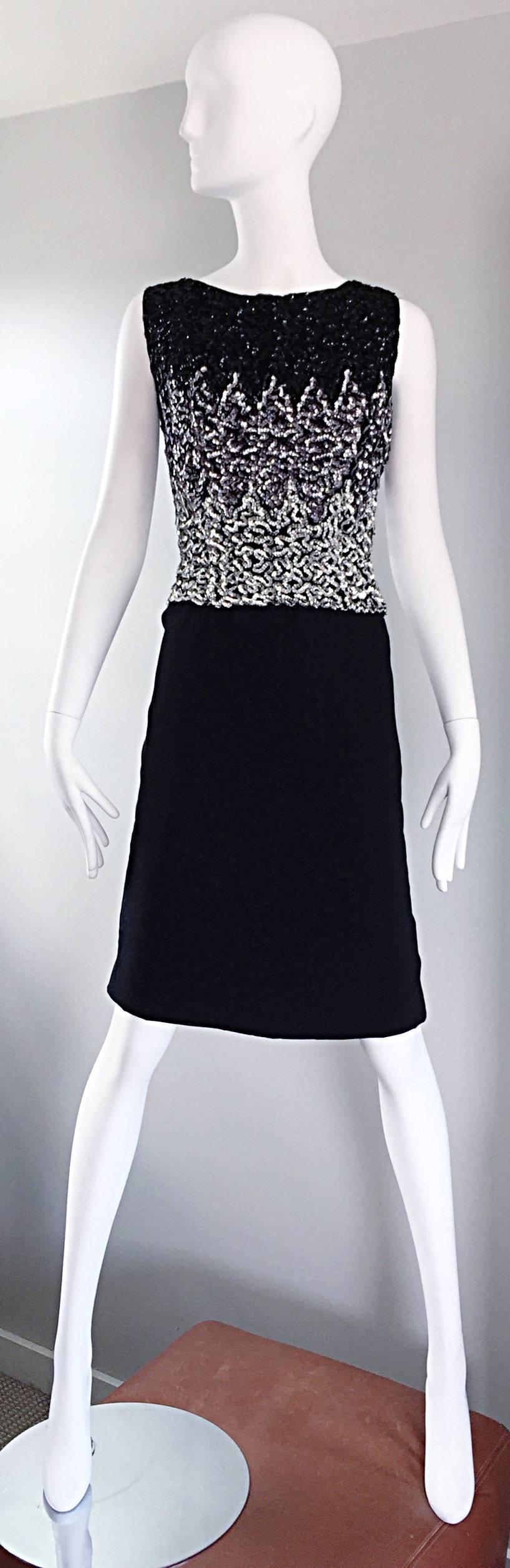 Sensational late 1950s black, silver and gunmetal sequined wiggle shift dress! Features allover hand-sewn sequins throughout the front and back of the bodice. Peek-a-boo at the top back with button closure. Great fit, and easy to wear. A timeless