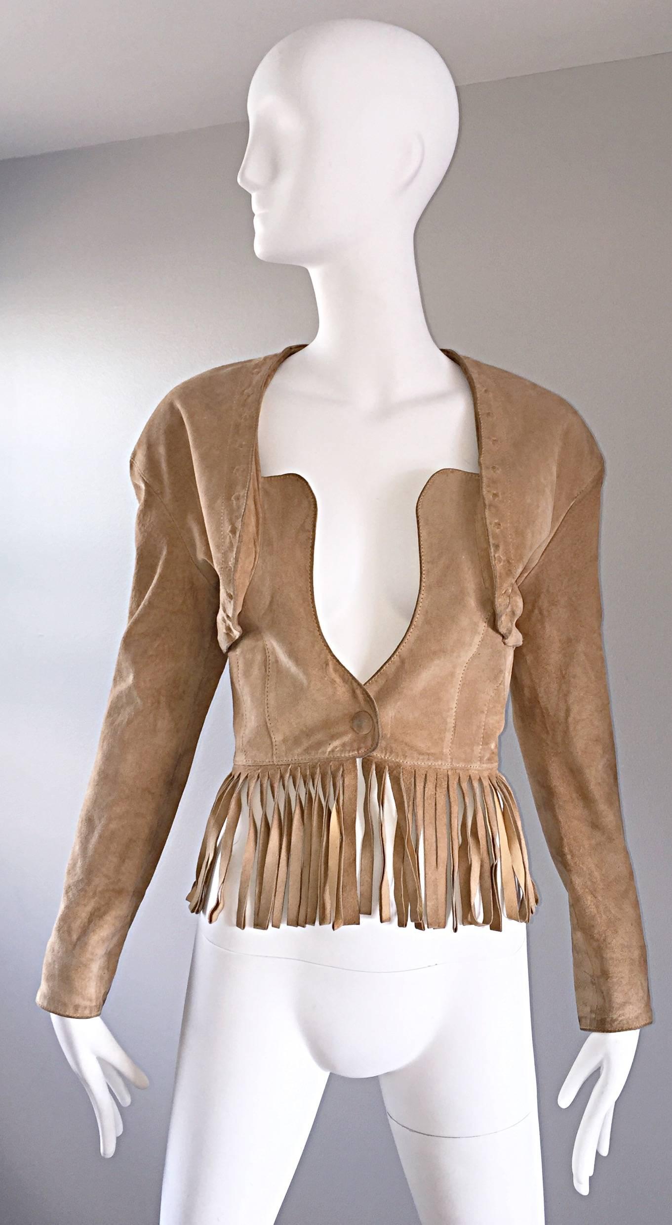 Amazing vintage 90s JEAN CLAUDE JITROIS tan / beige leather suede fringe jacket! Features a fringed hem across the front and back. Bustier style closure. Wonderful fitted bodice with tailore sleeves. Snap at waist and at each sleeve cuff. Fully