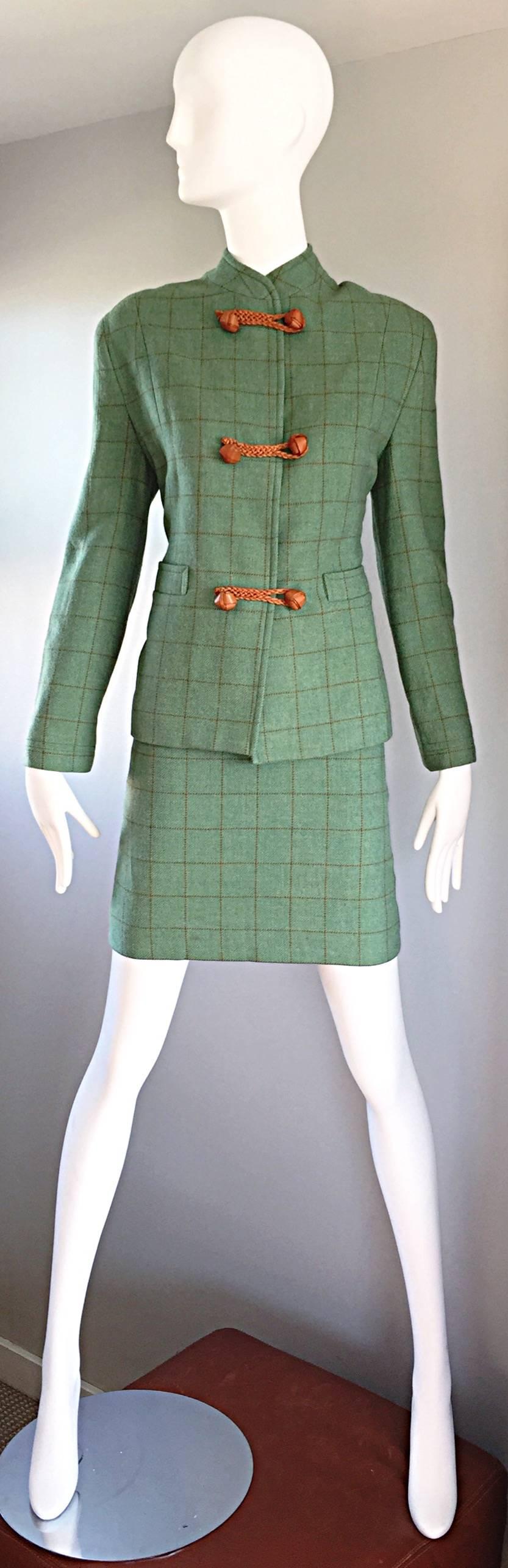 Sophisticated and flattering vintage ISAAC MIZRAHI green and brown plaid skirt suit! Asian inspired blazer, with tan leather braided closures up the bodice, Pockets at both sides of the waist. High waisted tailored pencil skirt, with hidden zipper