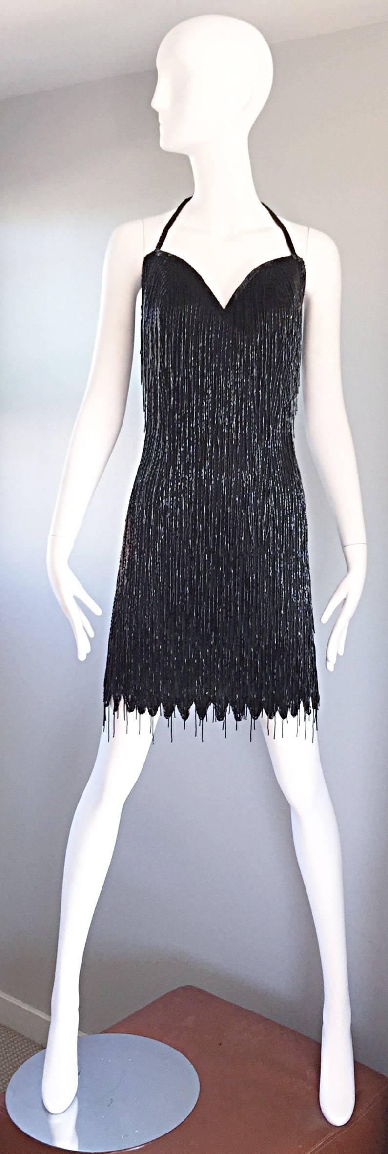 Amazing vintage black silk heavily beaded fringed 'Flapper' style 1990s does 1920s halter dress! Features thousands of hand-sewn black beaded tassels over the entire dress. Scalloped hem. Boned bodice, with a hidden zipper up the back, and