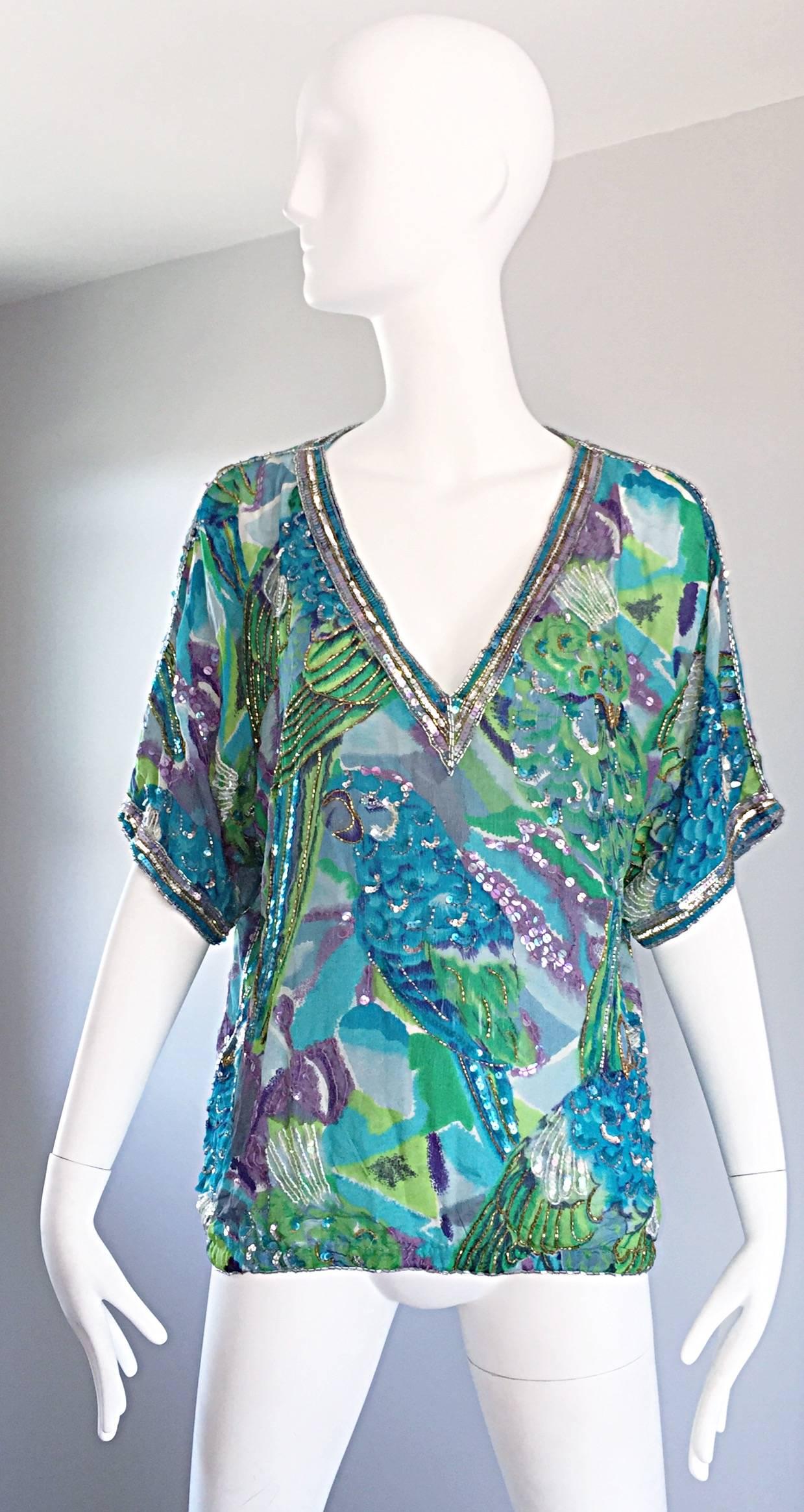 Brilliant vintage LILLIE RUBIN silk sequined and beaded 'parrots' top! Features vibrant colors of blue, purple, green and white throughout. Hand-sewn sequins add just the right amount of shine! V-neckline with hand-sewn seed beads and sequins